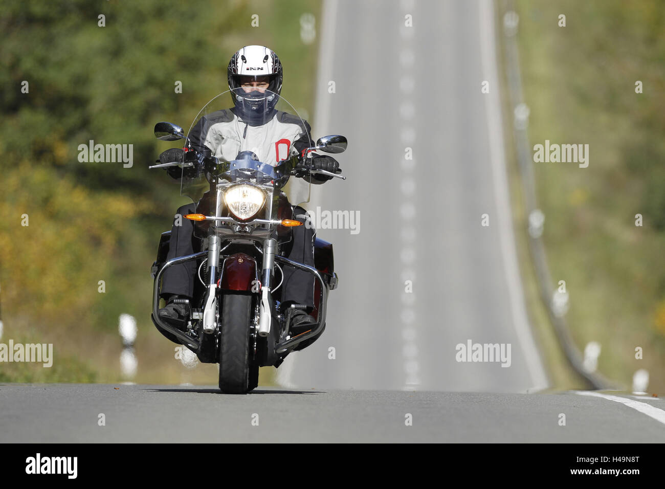 Motorcyclist, motorcycle, straight country road, basin, travel motorcycle, Victory, from the front, Stock Photo