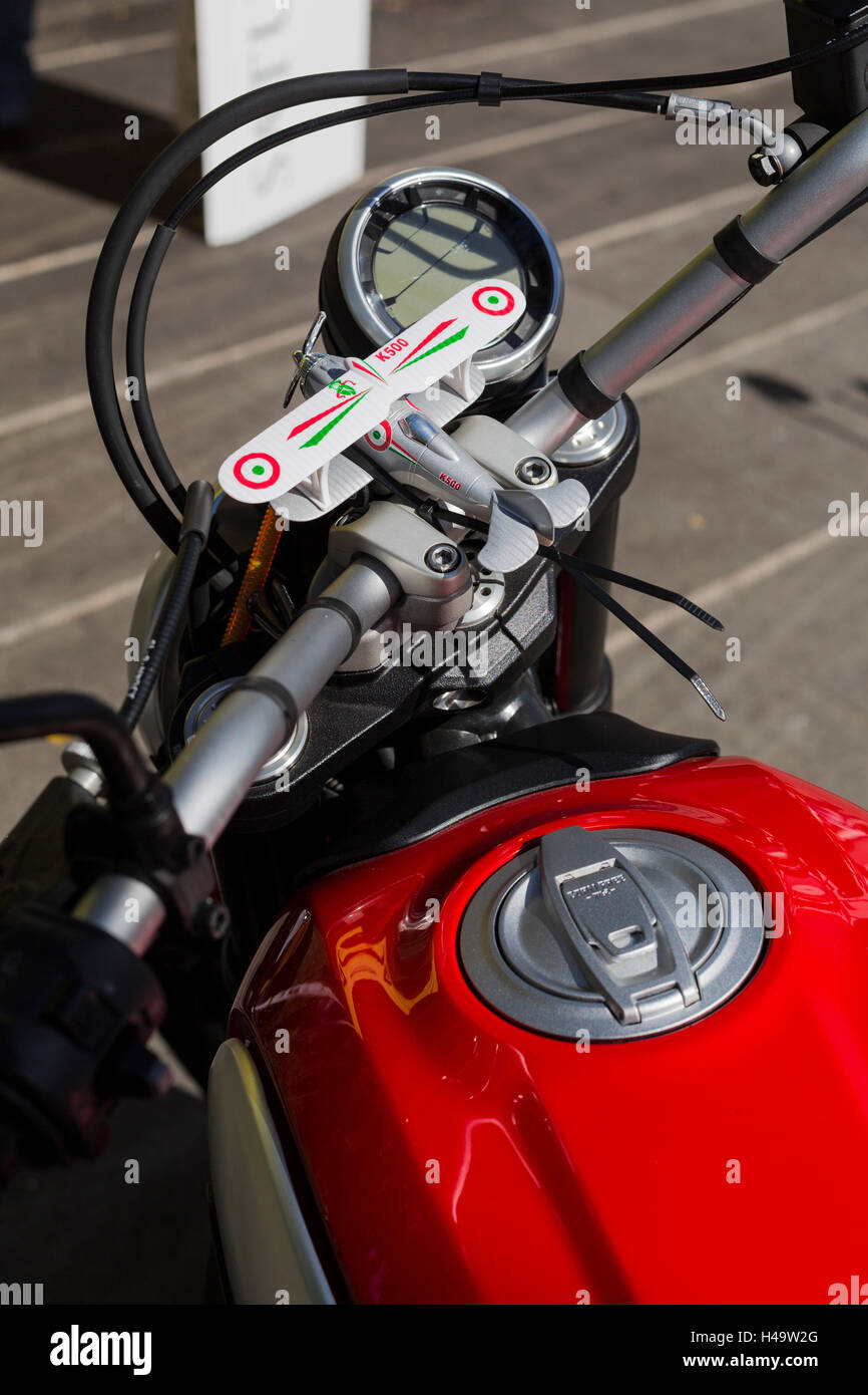 Toy Biplane Strapped To The Handlebars Of A Ducati Scrambler Motorcycle Stock Photo Alamy
