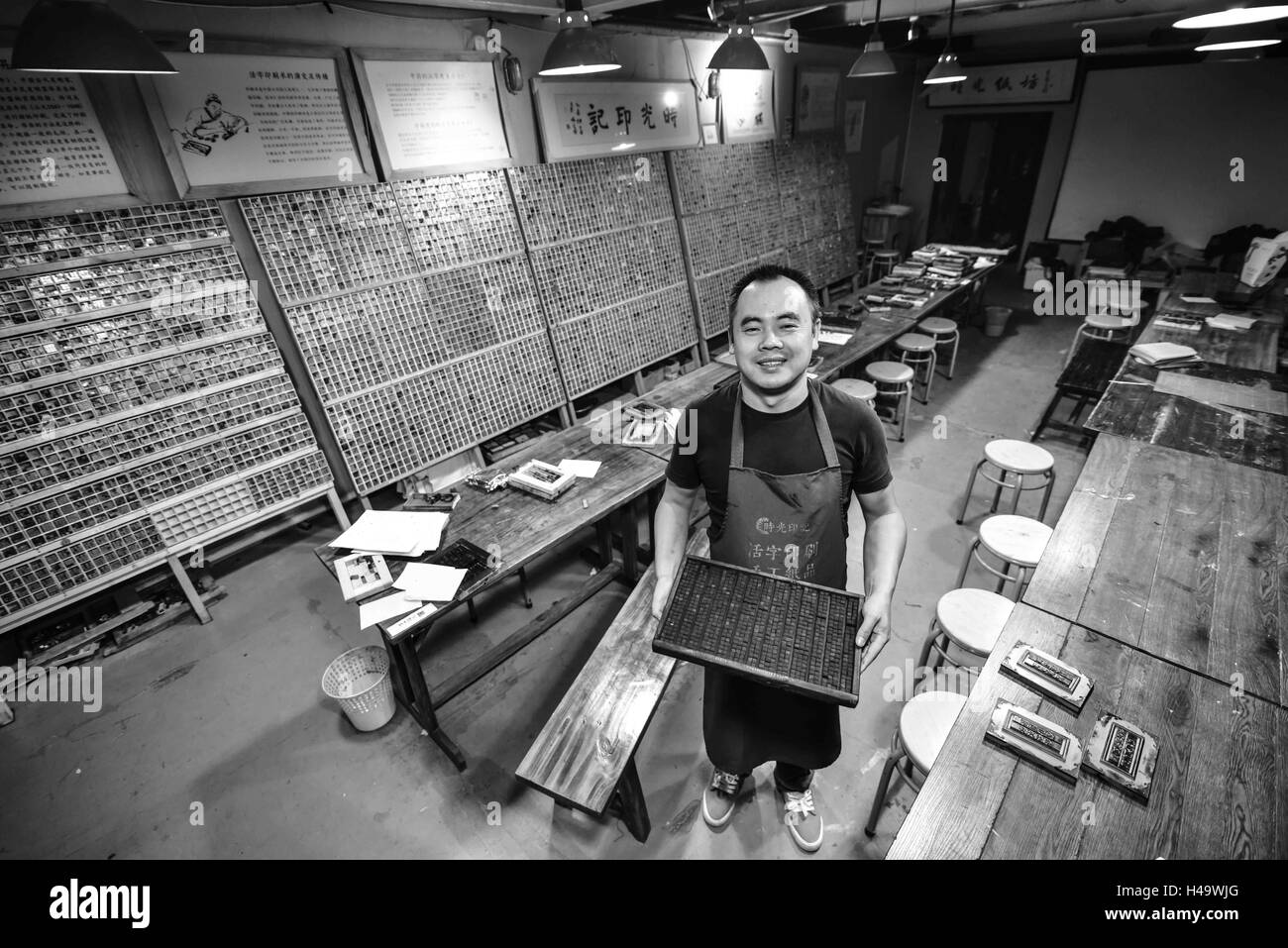 Qingdao, Qingdao, China. 14th Oct, 2016. Binzhou, CHINA-October 13 2016: (EDITORIAL USE ONLY.CHINA OUT) Ruan Tongmin works in his studio of movable type printing in Qingdao, east China's Shandong Province, October 14th, 2016. Ruan Tongmin, born in a family of printing, is fond of studying on the industry of printing. He has collected hundreds of various printing machines and established a studio specializing on movable type printing, aiming to revitalize Chinese traditional culture of movable type printing. Movable type is the system and technology of printing and typography that uses movab Stock Photo