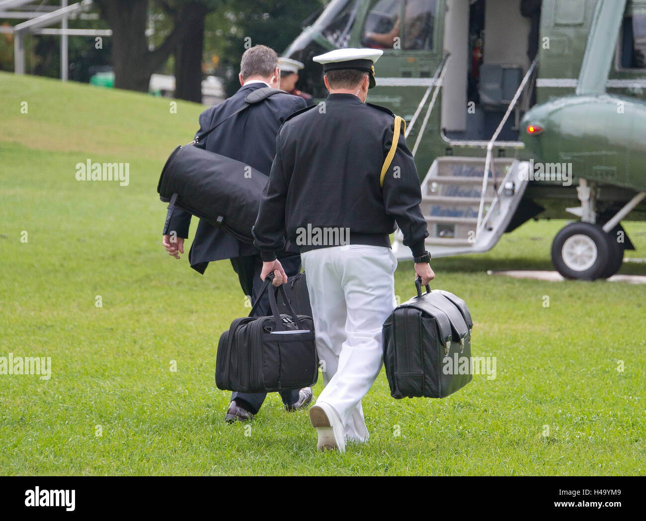 A United States Marine walks to Marine One with a briefcase holding nuclear launch codes to accompany US President Barack Obama as he departs the South Lawn of the White House in Washington, DC on Thursday, October 13, 2016 en route to Joint Base Andrews in Maryland for a trip to Pennsylvania and Ohio. Credit: Ron Sachs/CNP /MediaPunch Stock Photo