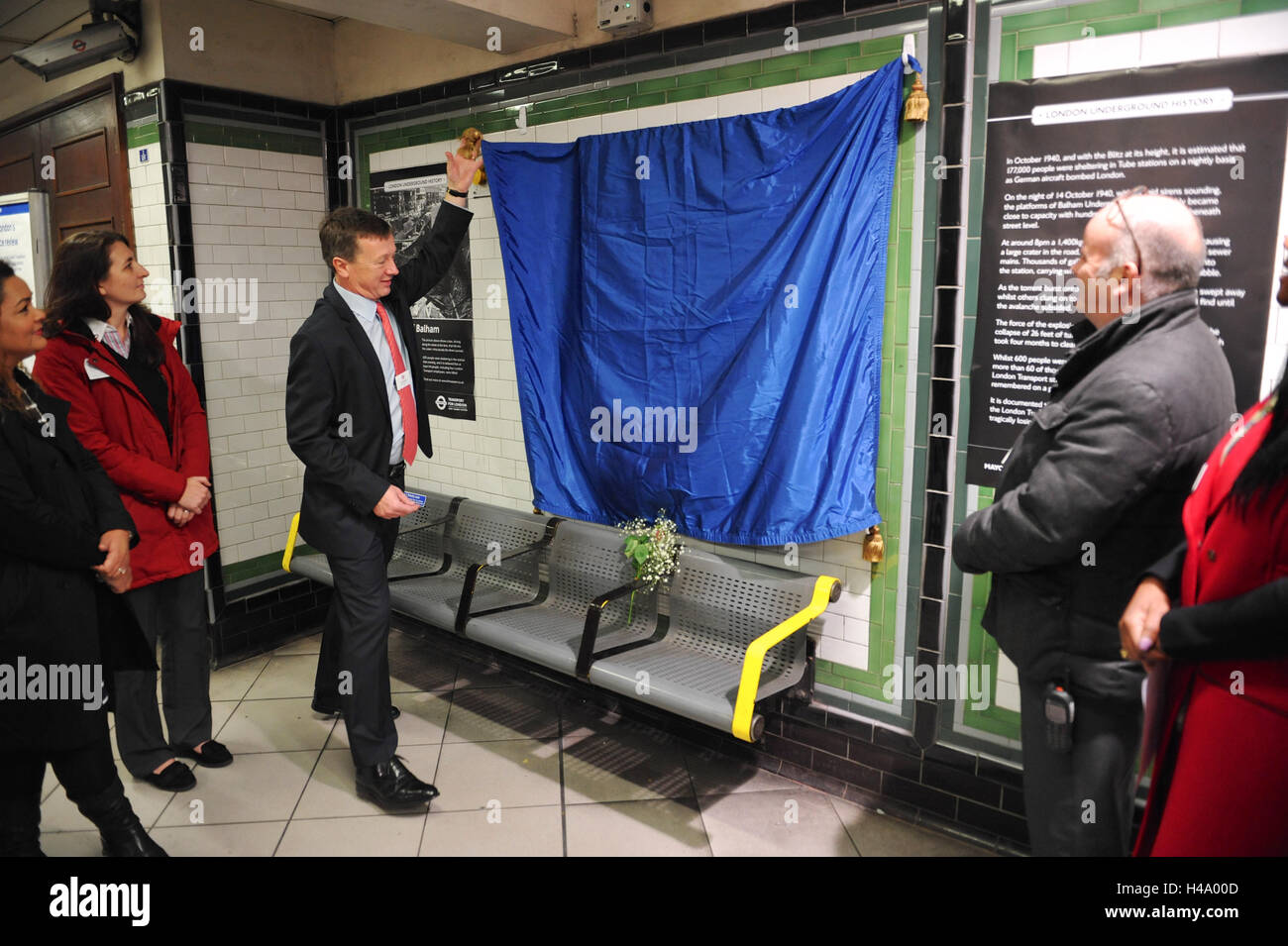 London, UK. 14th October, 2016. Brian Woodhead (TfL Operations Director for the Jubilee, Northern and Piccadilly Lines) unveiling the plaque.  The unveiled plaque commemorates 60 people killed during an air raid on the night of 14 October 1940 when a 1,400kg bomb fell on Balham High Road causing a large crater in the road. This led to a torrent of thousands of gallons of sewage and water entering the station.  Credit:  Michael Preston/Alamy Live News Stock Photo