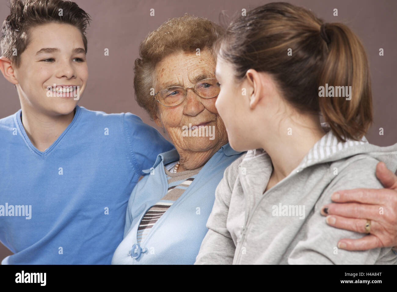 Grandmother embraces her grandchildren, Stock Photo