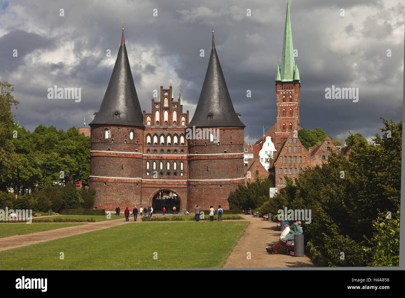 Germany, Schleswig - Holstein, Holstentor, church, piece Peter, Lübeck, town, Hanse, the Baltic Sea, goal, architecture, Hanseatic town, towers, place of interest, landmark, structure, tourist, pedestrian, summer, thunderstorm, stormy atmosphere, meadow, Stock Photo