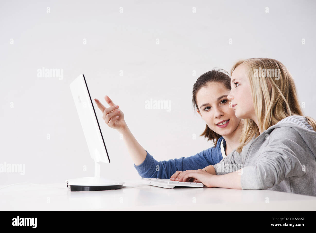 Teenagers, girls, two, computer, at the side, studio, young persons ...