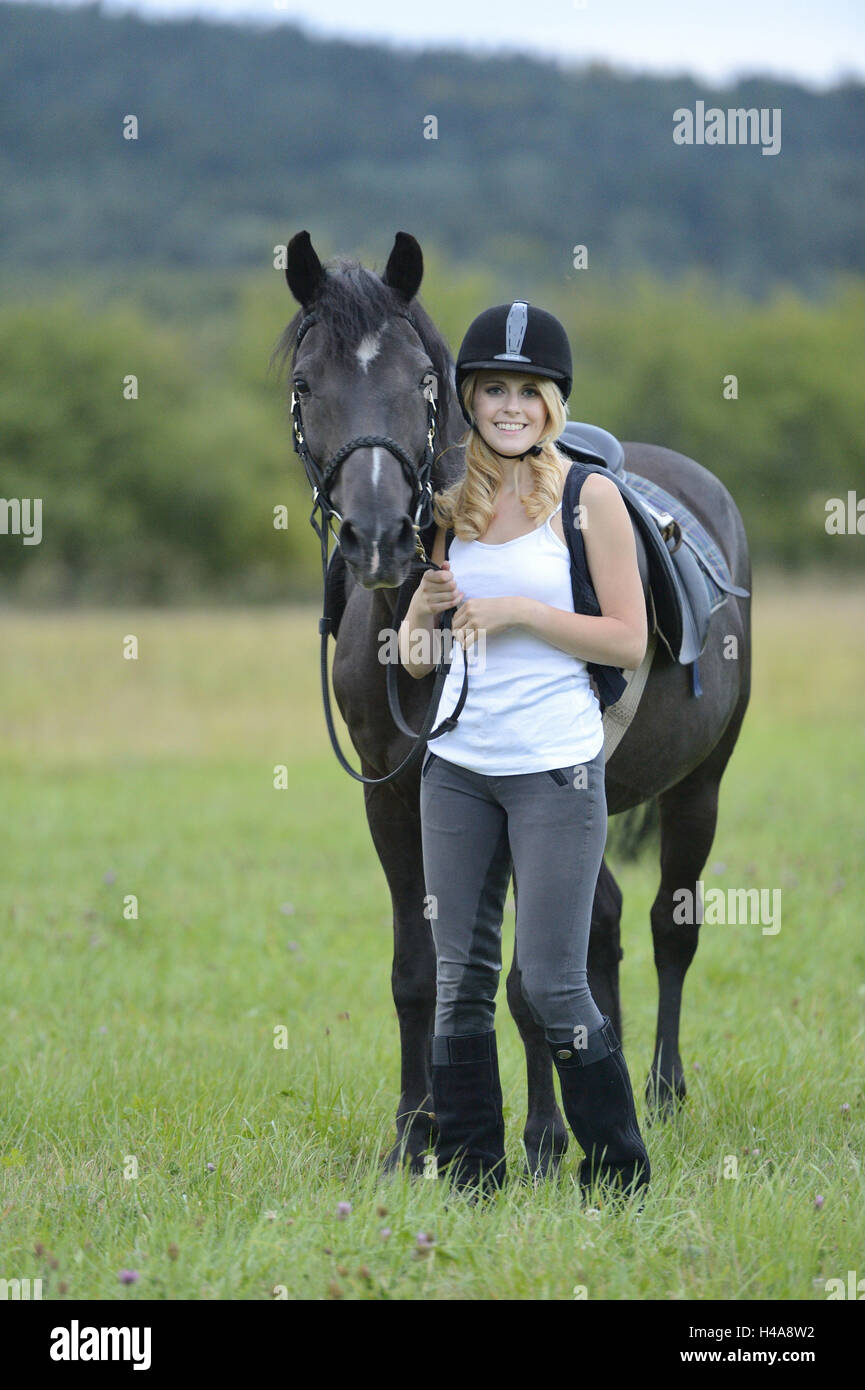 Teenage girl, horse, Arabo-Haflinger, meadow, stand, head-on, view camera, Stock Photo