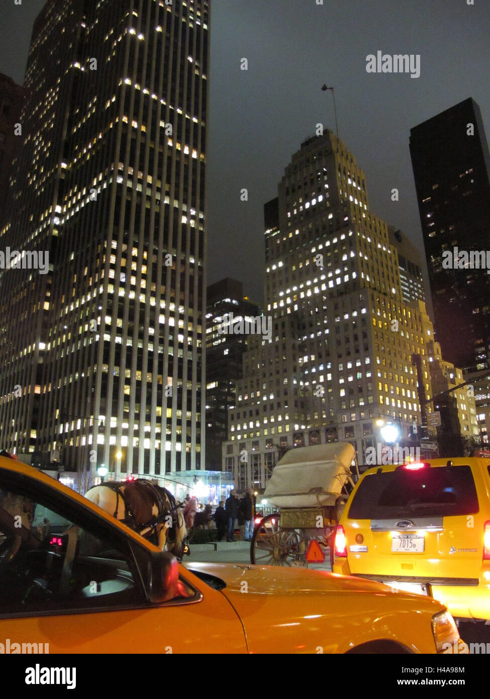 USA, New York City, 60th Street and Fifth avenue, high rises, yellow cabs, evening, Stock Photo