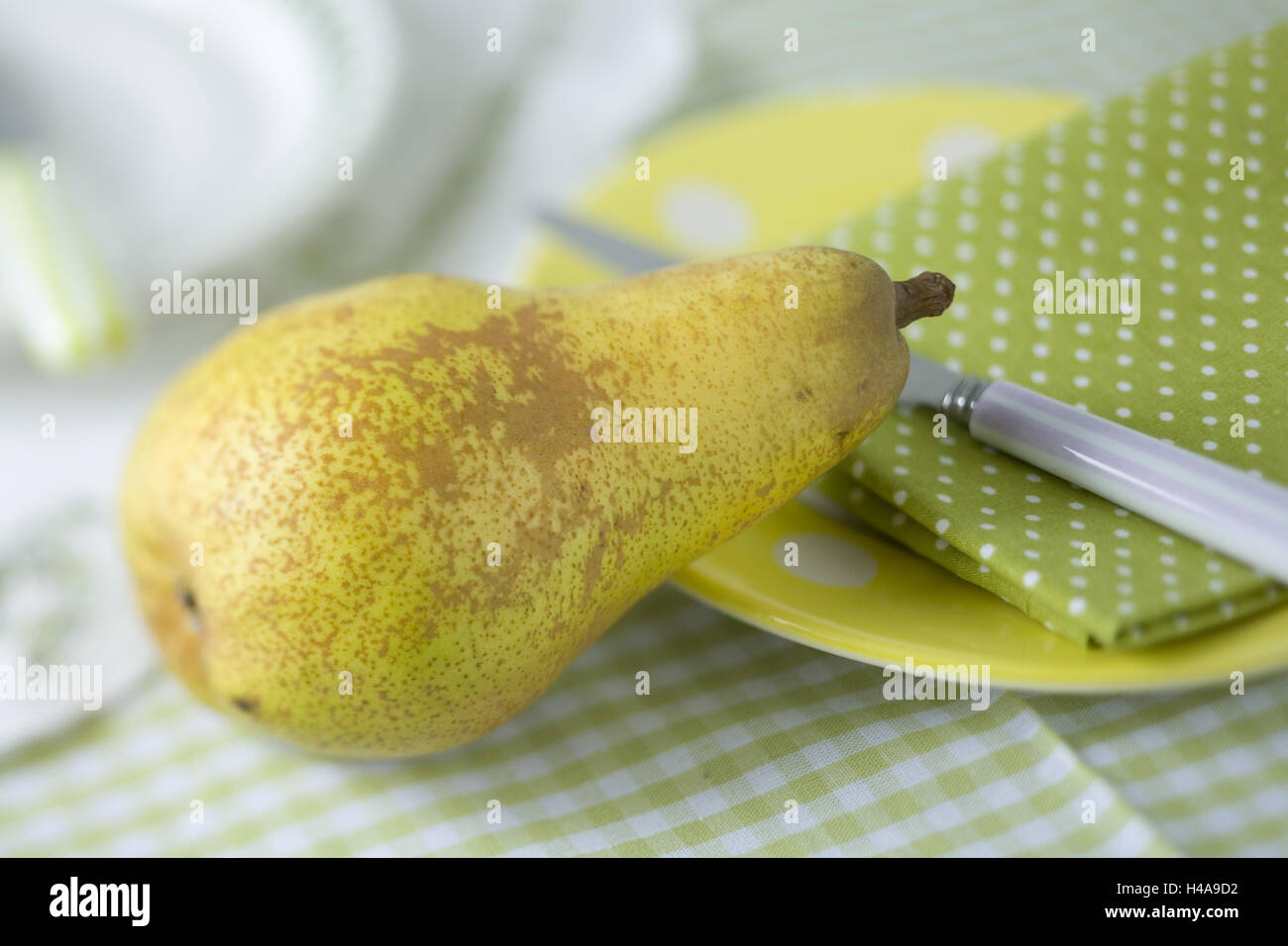 Pear with plate, napkin and knife, Stock Photo