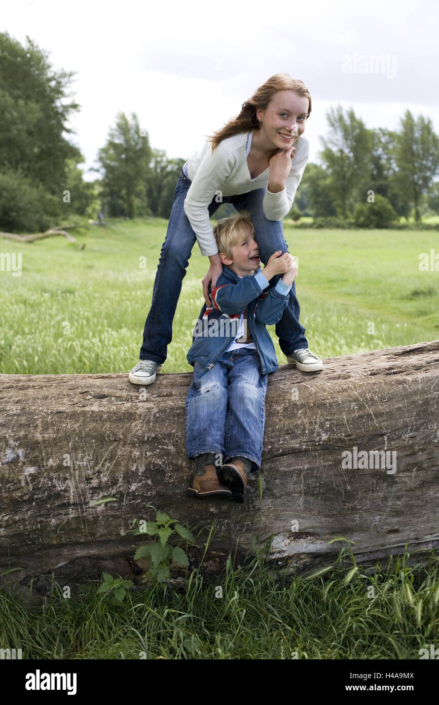 Trunk, young persons, boy, fun, happy, people, child, childhood, siblings, girls, sister, brother, blond, teenager, baby sitter, walk, spring, autumn, outside, meadow, leisure time, scenery, rurally, week-end, nature, laugh, play joy, trunk, pay attention, sit stupidly, melted, protect, carefree nature, whole bodies, Stock Photo