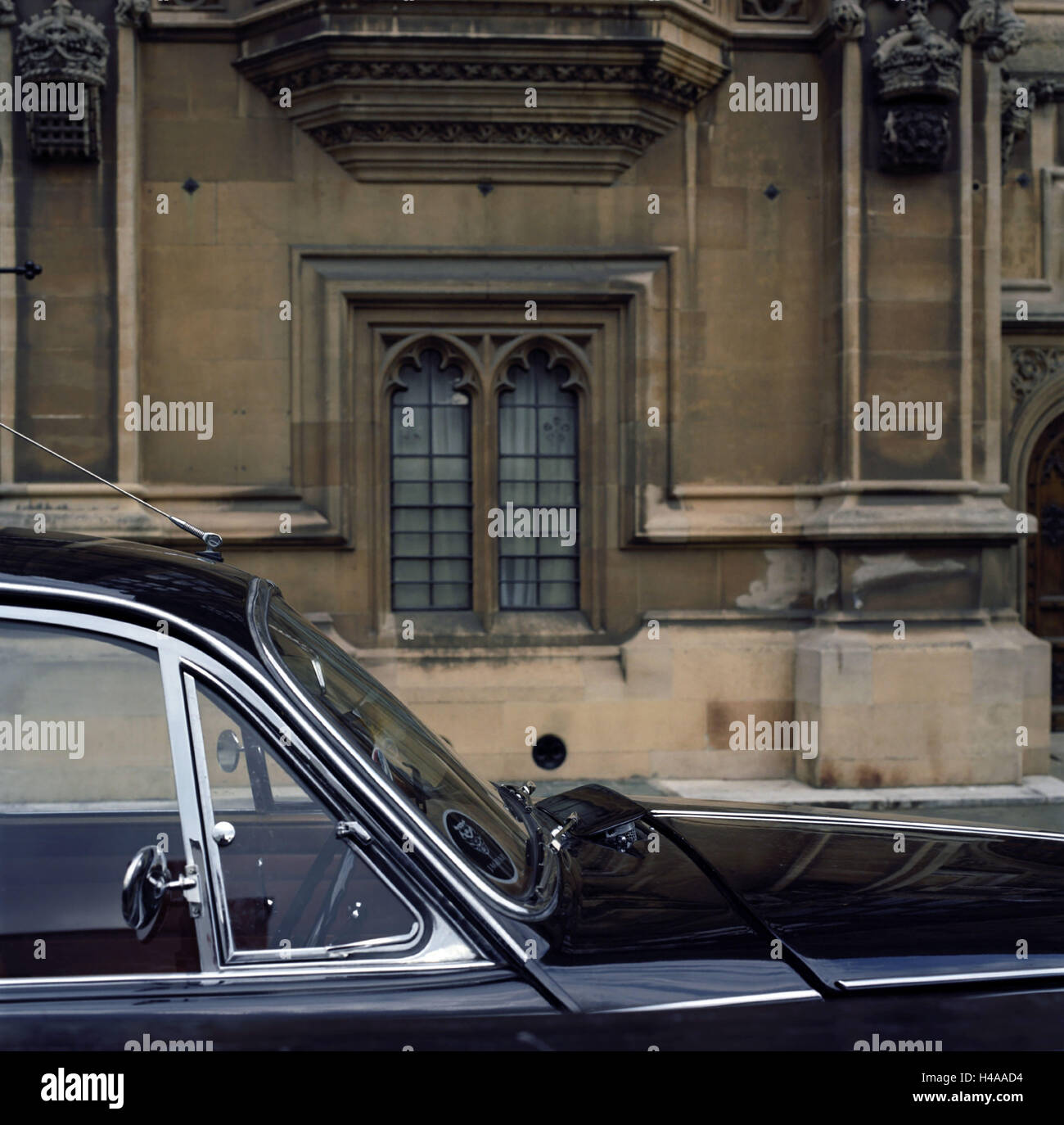 Vintage car on parking lot in front of the Houses of Parliament, London