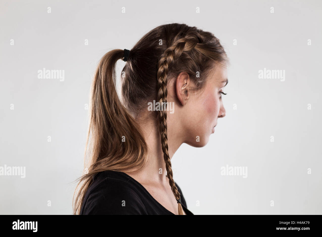 Instructions braided hairstyle with bun step 2 of 3 Stock Photo