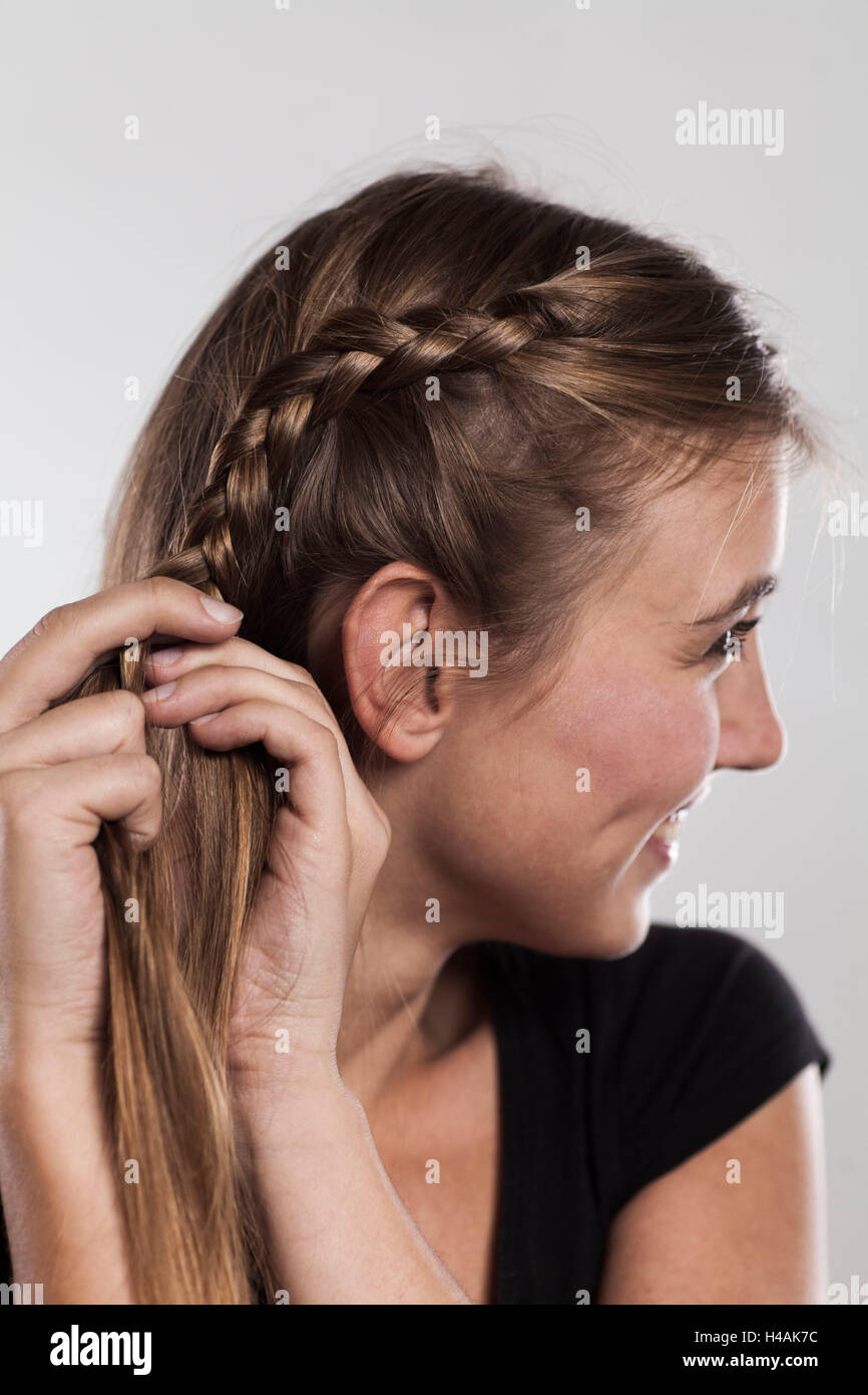 Instructions braided hairstyle with bun step 2 of 3 Stock Photo
