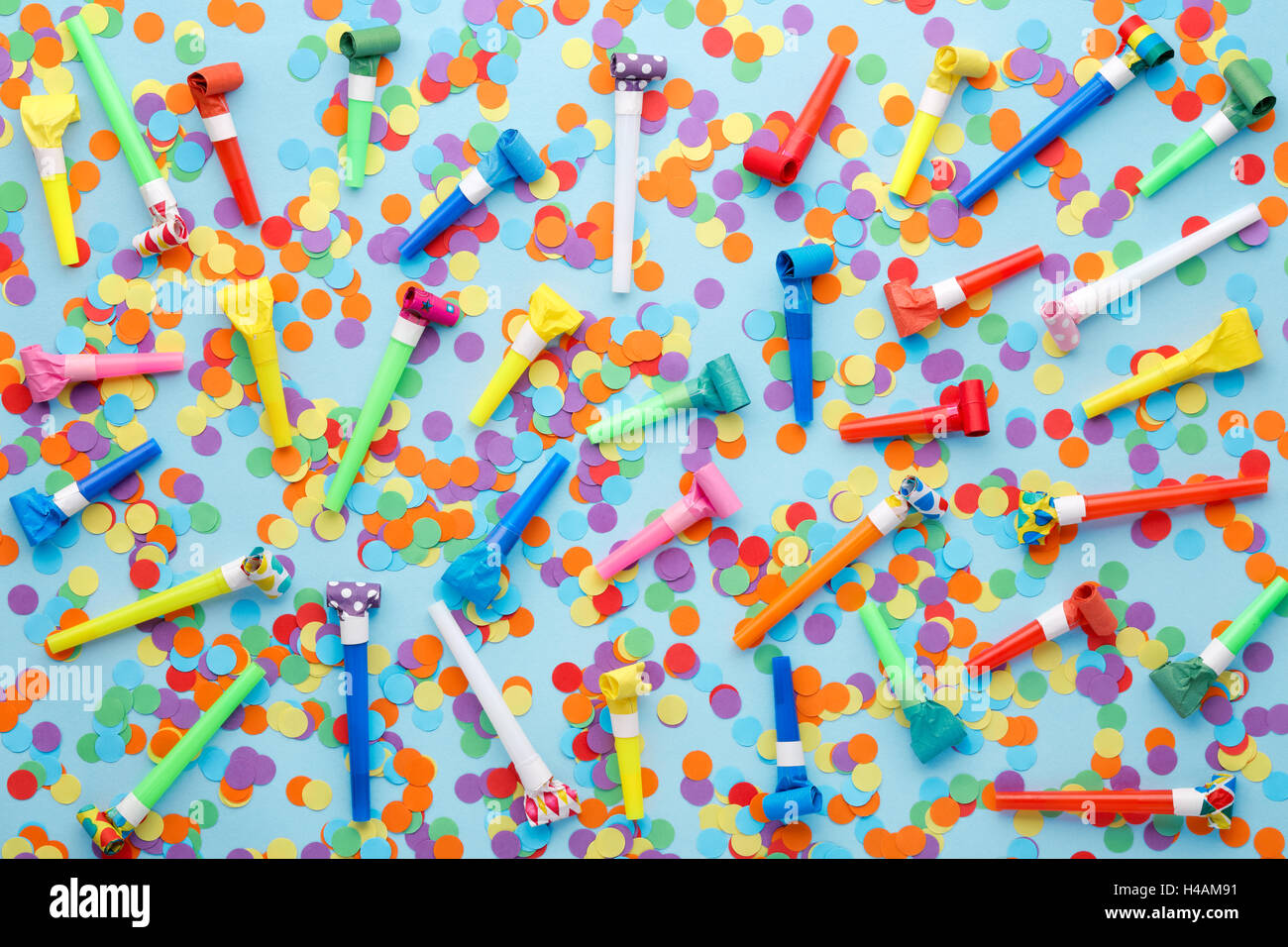 Party decoration,Confettis and whistles on blue background Stock Photo ...