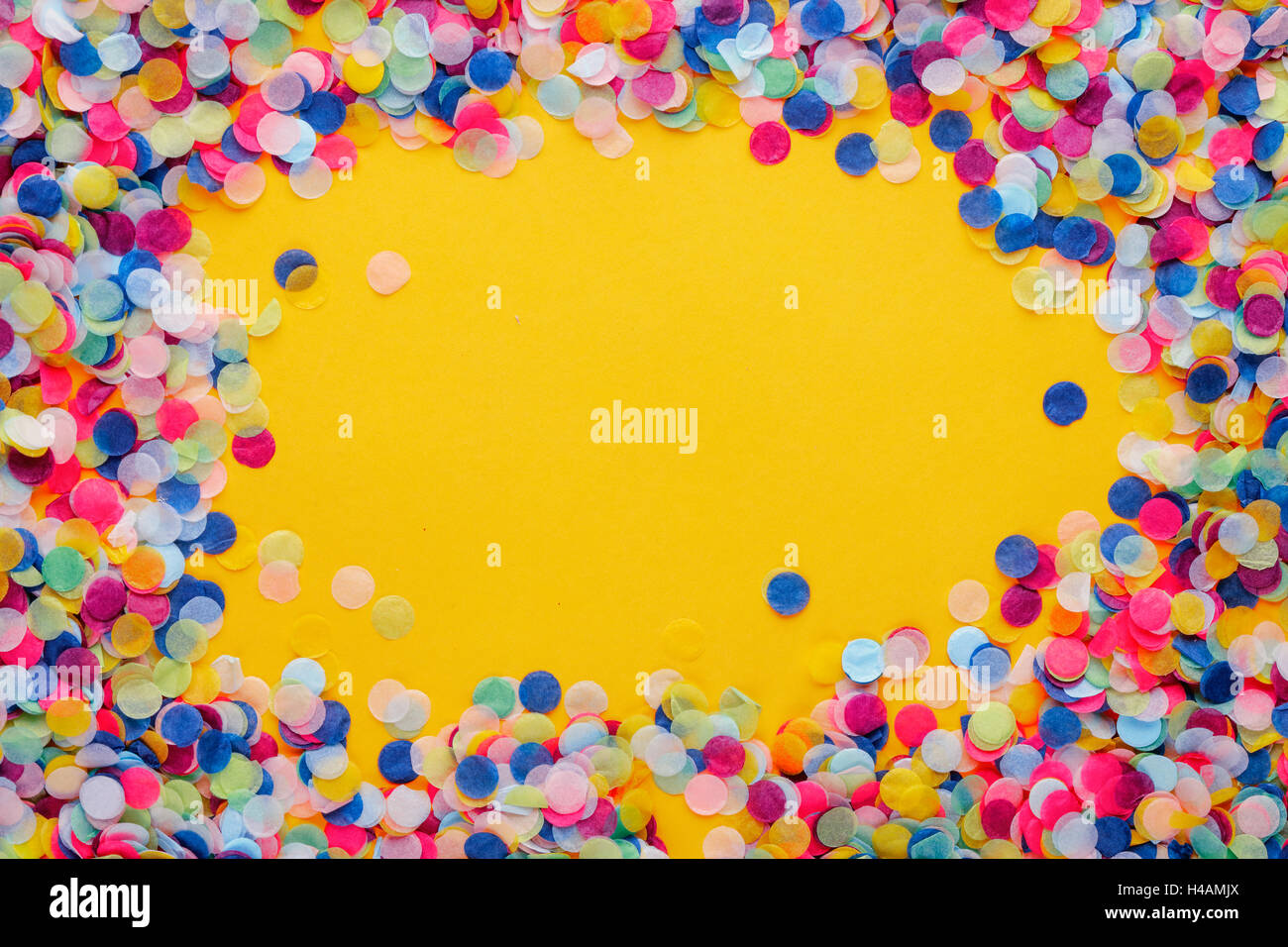 Colorful Confetti frame on yellow Background Stock Photo