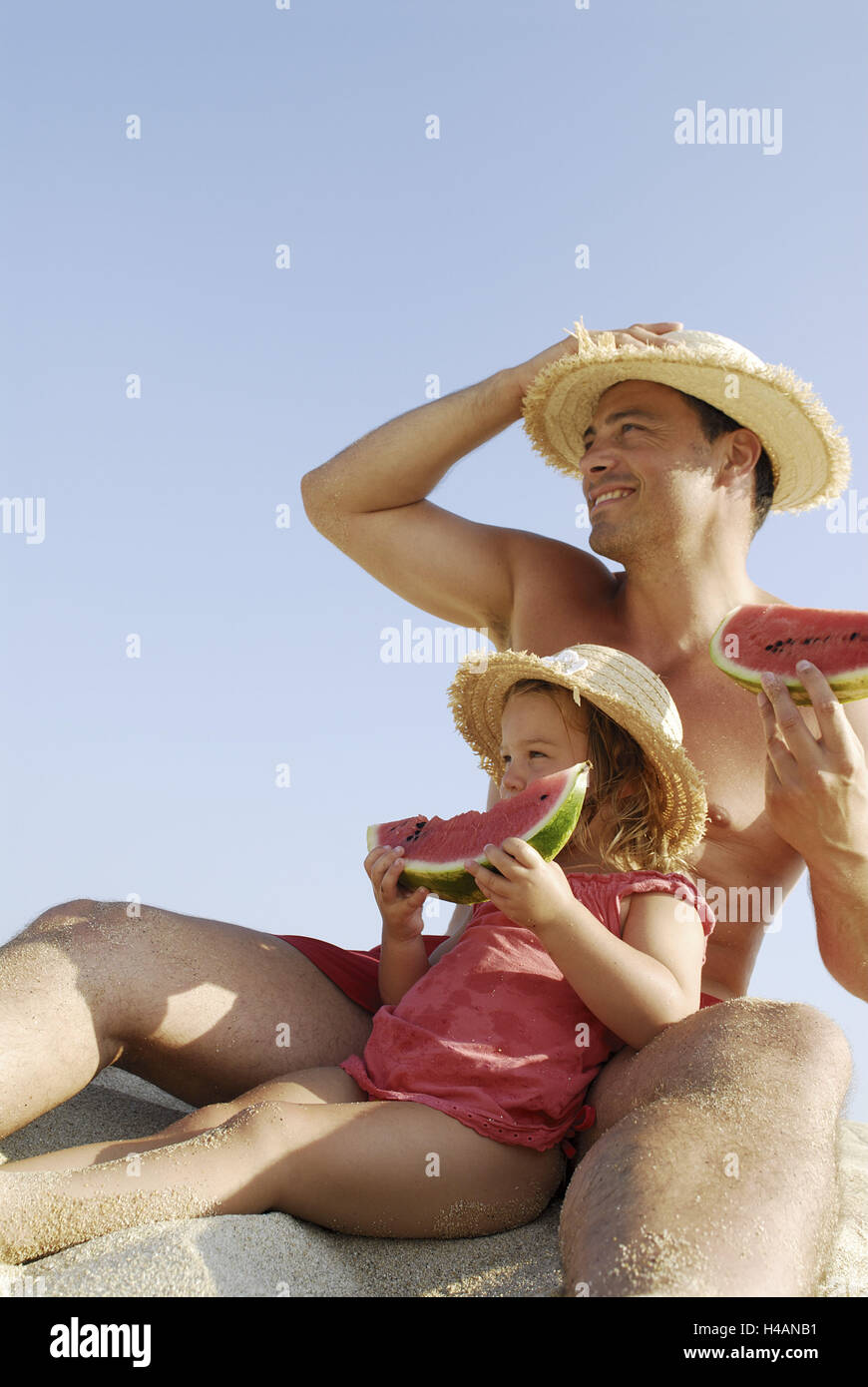 Girls, man, beach, sit, eat melon, Stock Photo