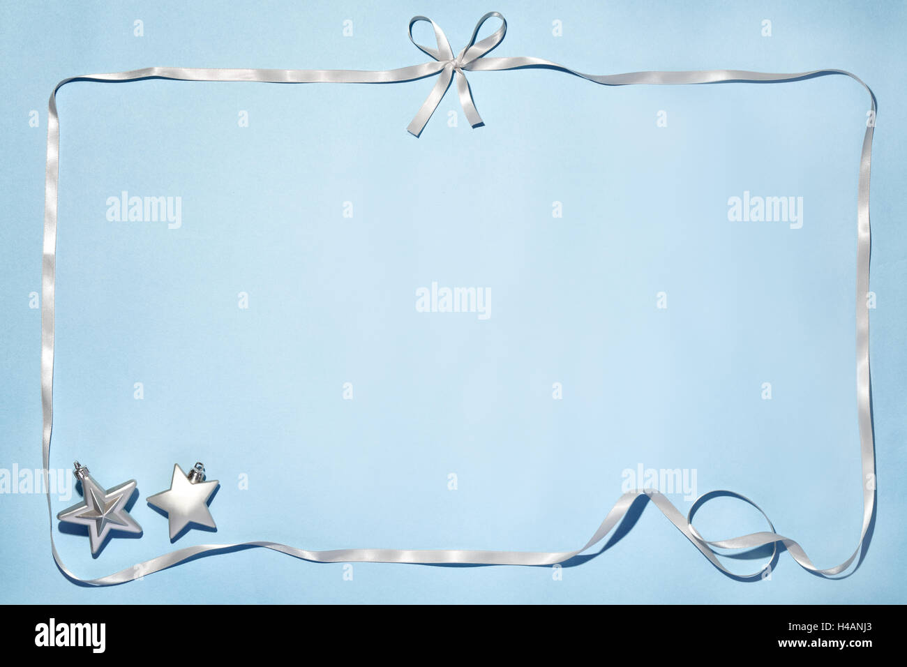 Silver ribbon and stars on blue background Stock Photo