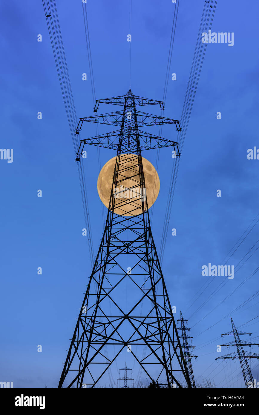 Germany, Hessen, Taunus, Niedernhausen, high-voltage poles and high-tension circuits with full moon, Stock Photo