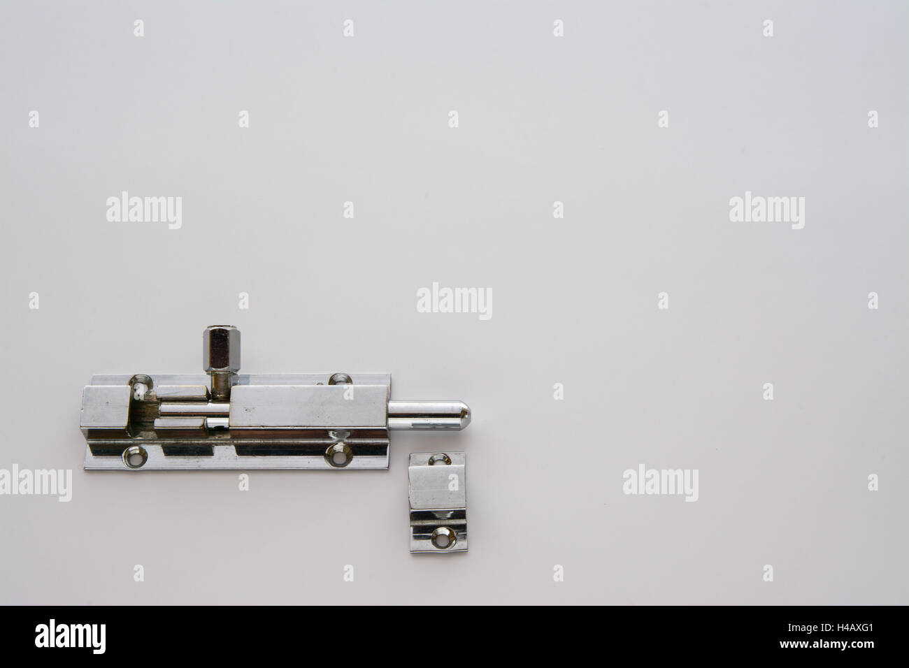 Silver door bolt with door jamb section obviously incorrectly placed Stock Photo