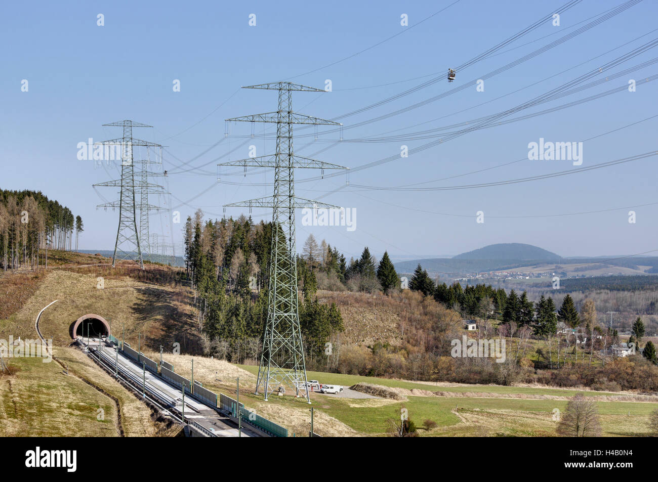 Man working on high voltage power lines, gondola, Thuringian Forest Stock Photo