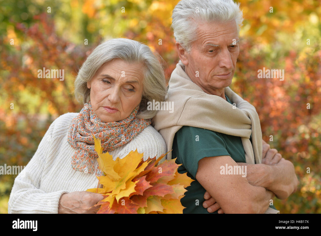 Sad elderly couple standing outdoors Stock Photo
