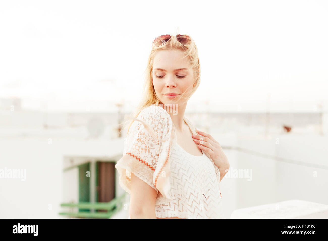 young woman in summer clothes on roof terrace Stock Photo
