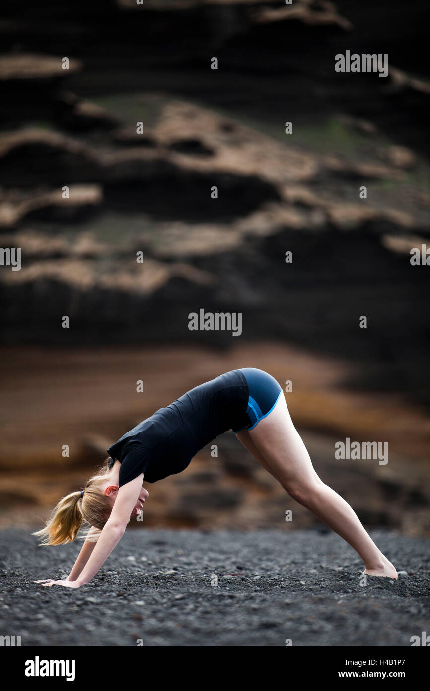 young woman doing yoga and Pilates - exercise 'dog' Stock Photo