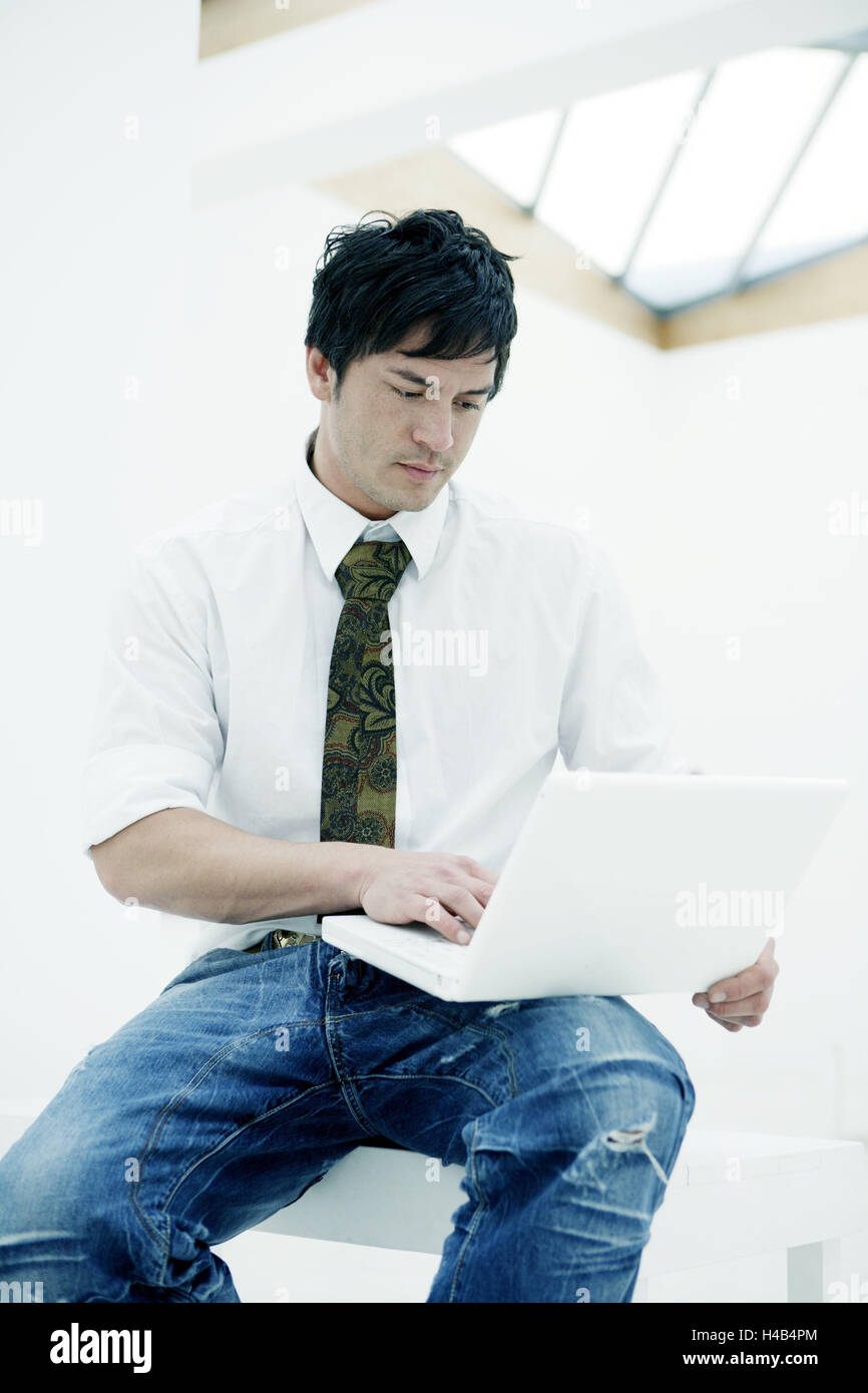 man, young, sitting, easygoing, laptop, data input Stock Photo