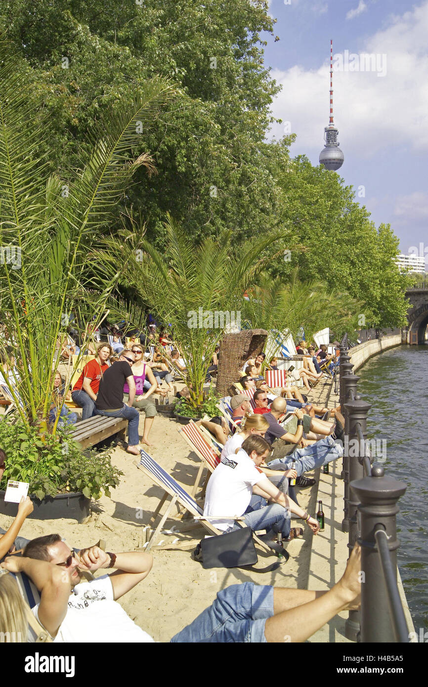 Germany, Berlin, Monbijoustrasse, Runable aground middle, beach, deck chairs, guests, Spree shores, summers, Berlin middle, event gastronomy, gastronomy, cafe, bar, beach bar middle, palms, trees, riversides, Sand, sandy beach, deck chairs, people, tourists, sit, sun themselves, leisure time, recreation, amusement, tourism, holiday feeling, radio tower, Stock Photo