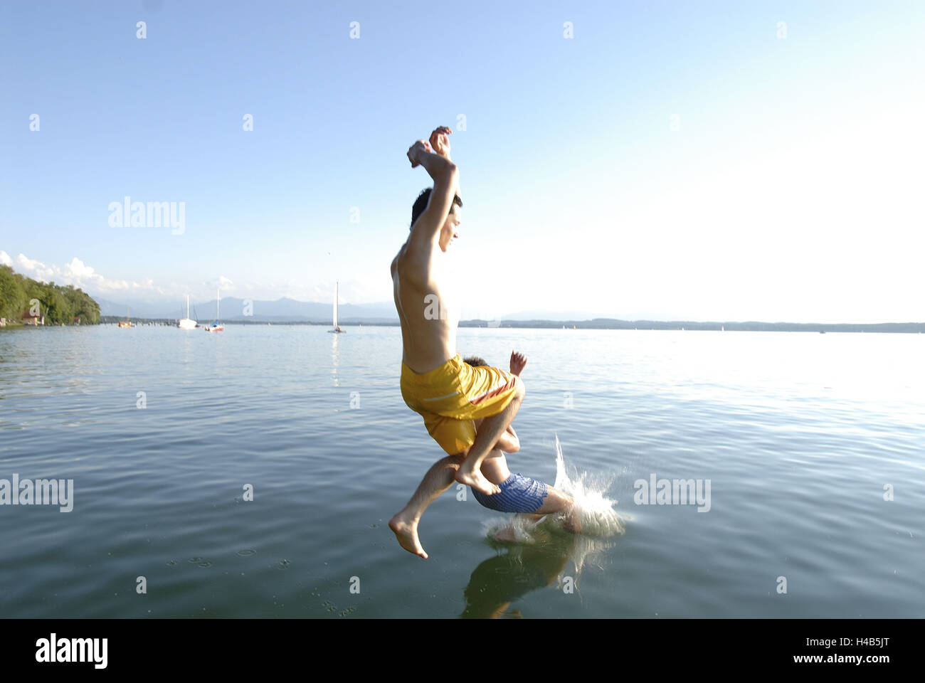 Men, two, young, lake, jump, Stock Photo