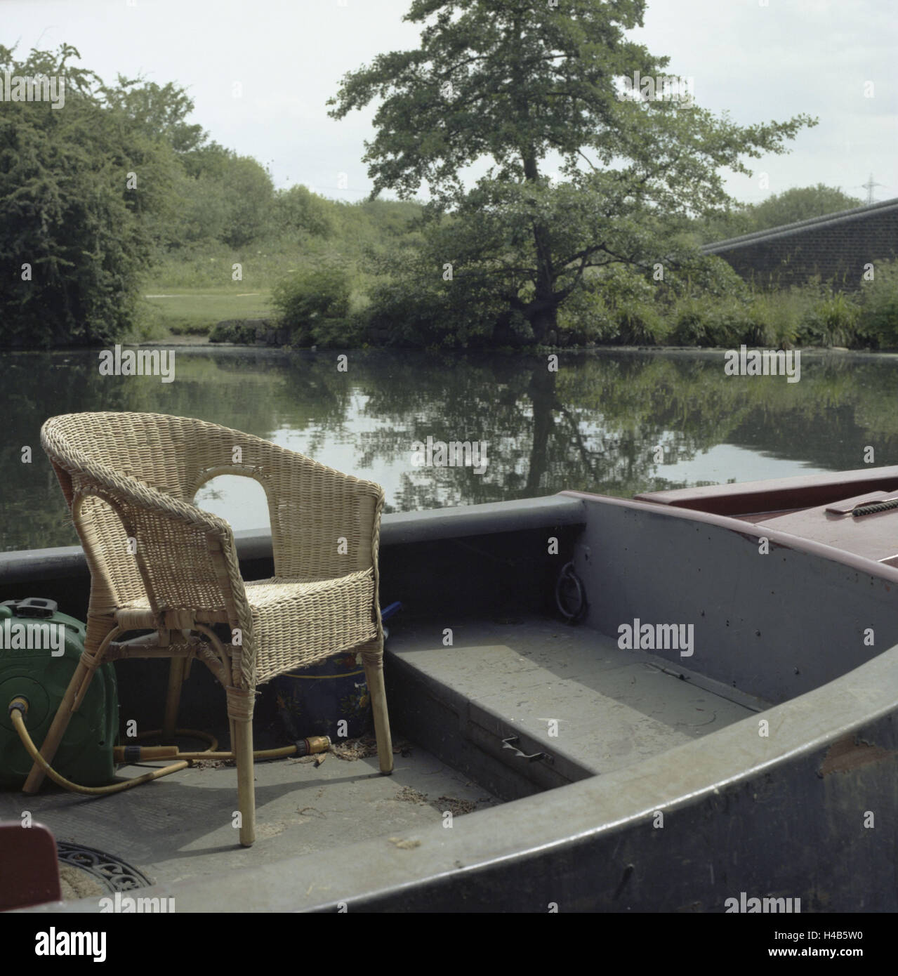 Houseboat and chair on 'Lea River Canal, inhabitant are sold by Olympia's setting, Stock Photo