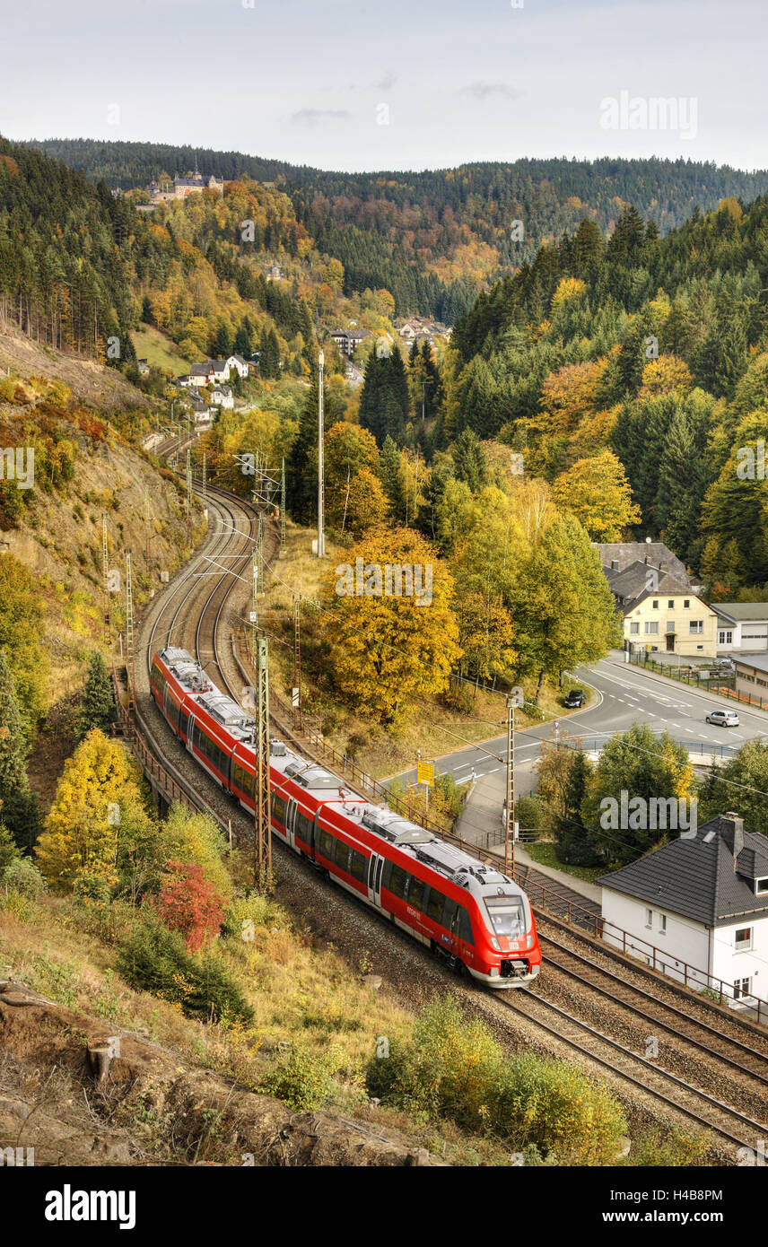 Railroad line winds along a mountainside, train, forest, scenery, castle, houses, Stock Photo