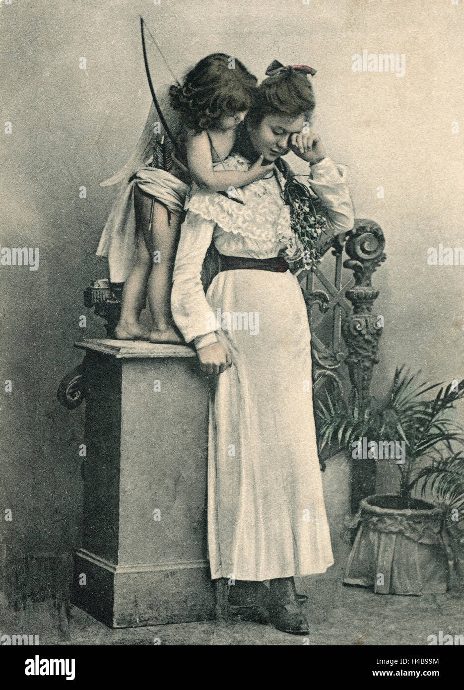 Postcard, historical, Amor comforts young woman, b/w, Stock Photo