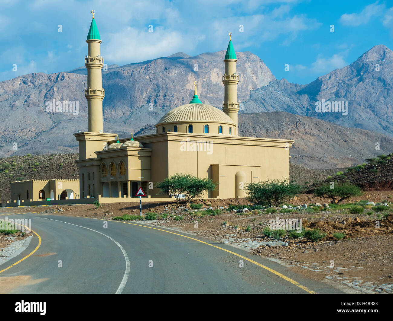 Mosque against mountain chain Jabal Misht, Hajar al Gharbi Mountains, Al Dhahirah Region, Arabia, Middle East, Oman Stock Photo