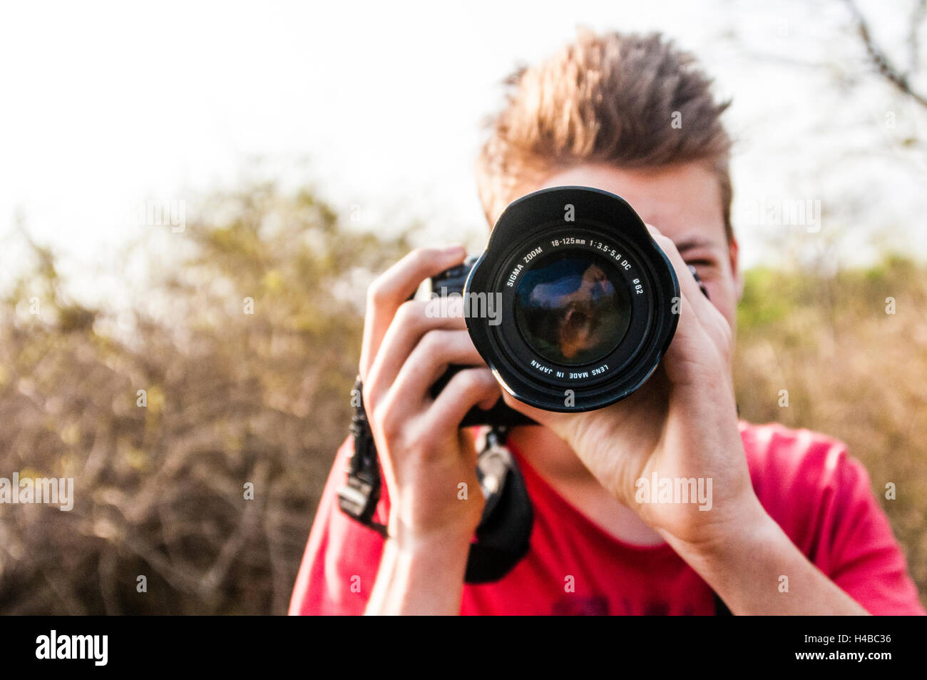 Young man photographing with a SLR Stock Photo