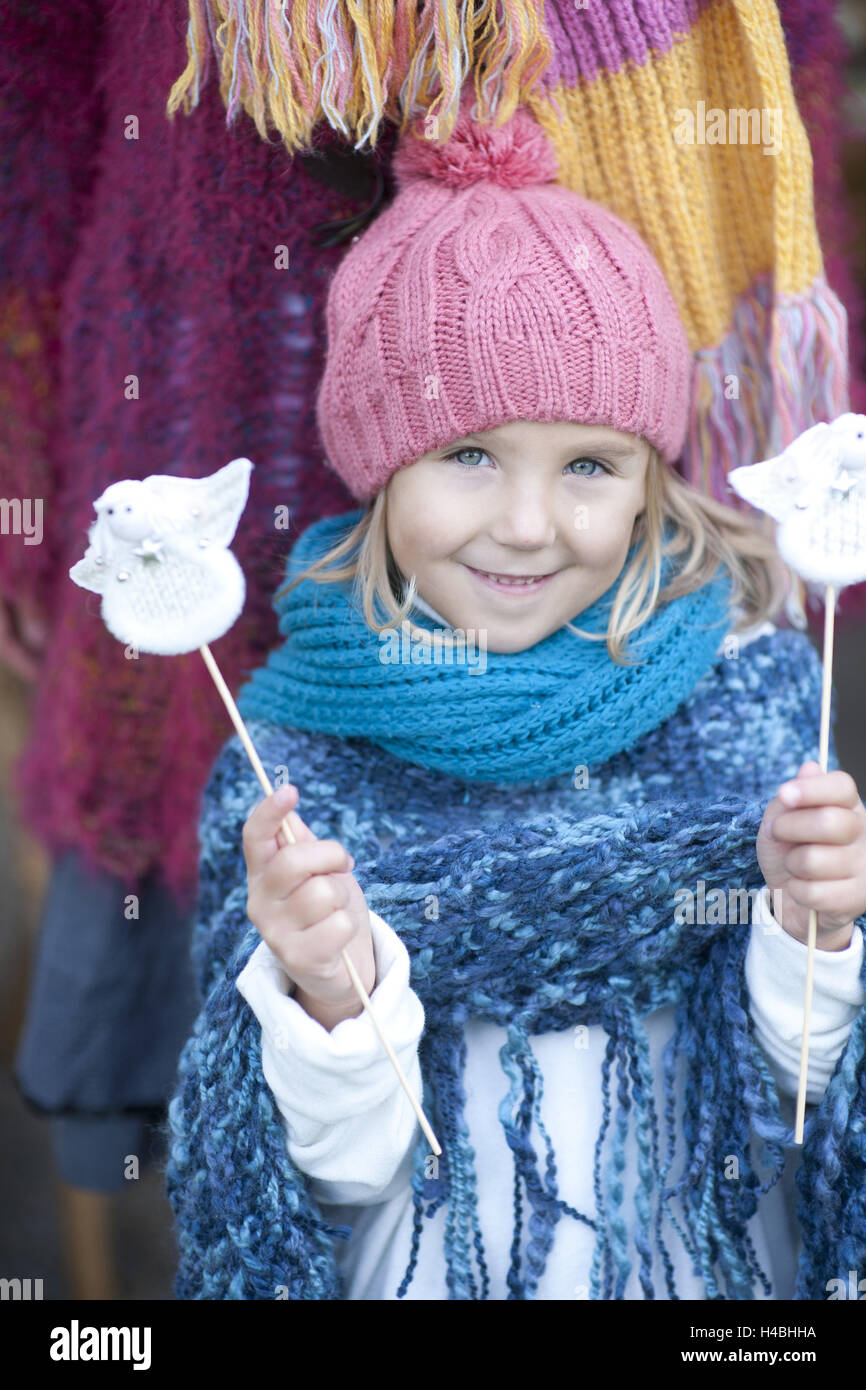 Girl, woolly hat, scarf, Christmas decoration, angel, holding, smiling, portrait, Stock Photo