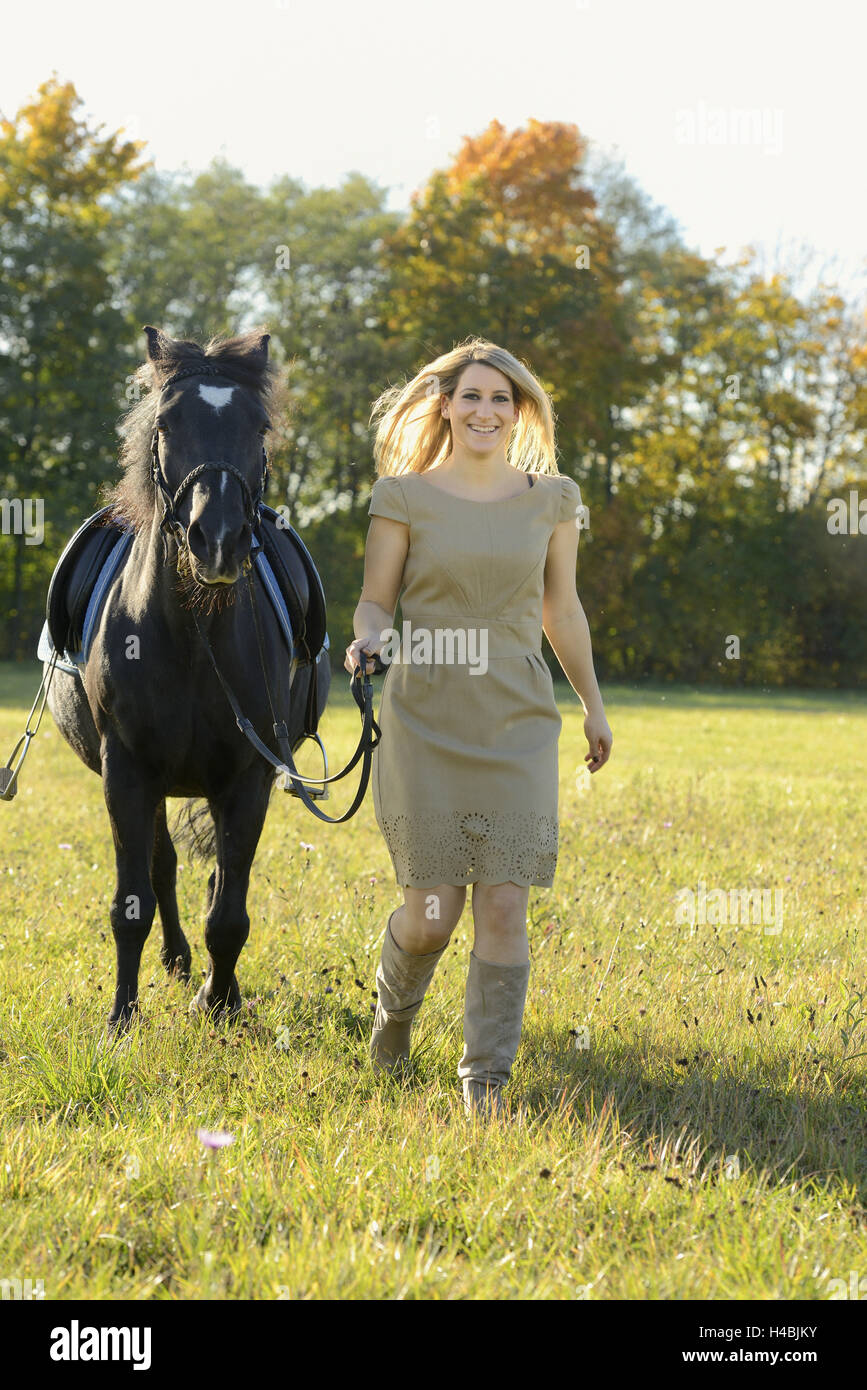 Teenage girl, horse, Arabo-Haflinger, meadow, lead, view camera, head-on, Stock Photo