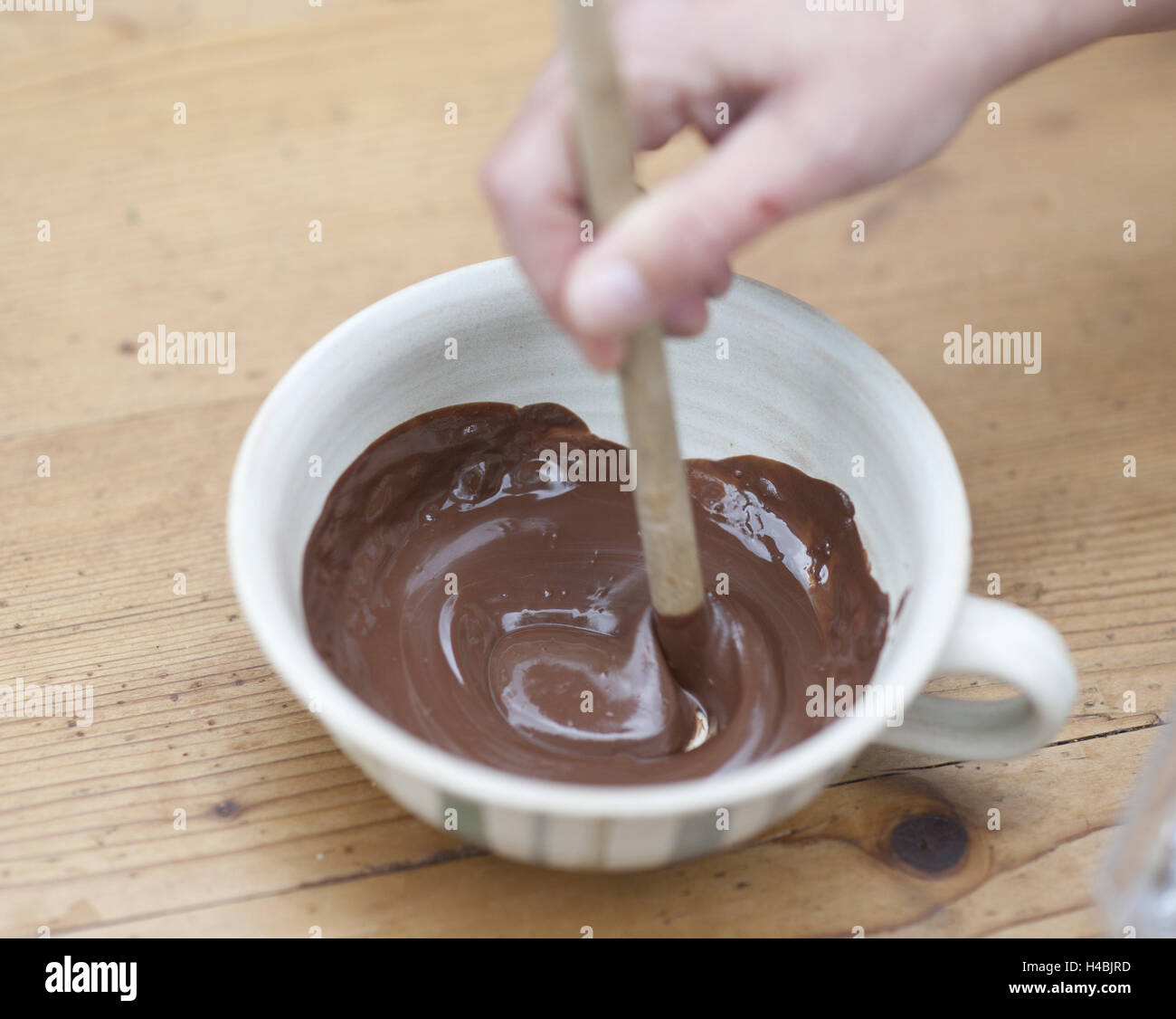 Woman stirs molten chocolate, medium close-up, Stock Photo