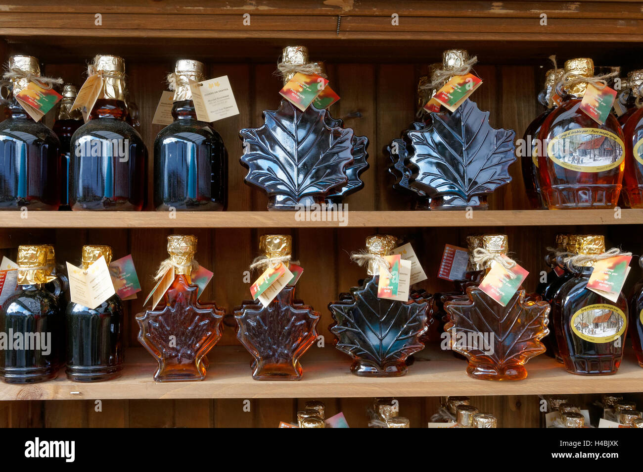 Bottles of Canadian maple syrup lined up on shelves at the Jean Talon Market, Montreal, Quebec, Canada Stock Photo