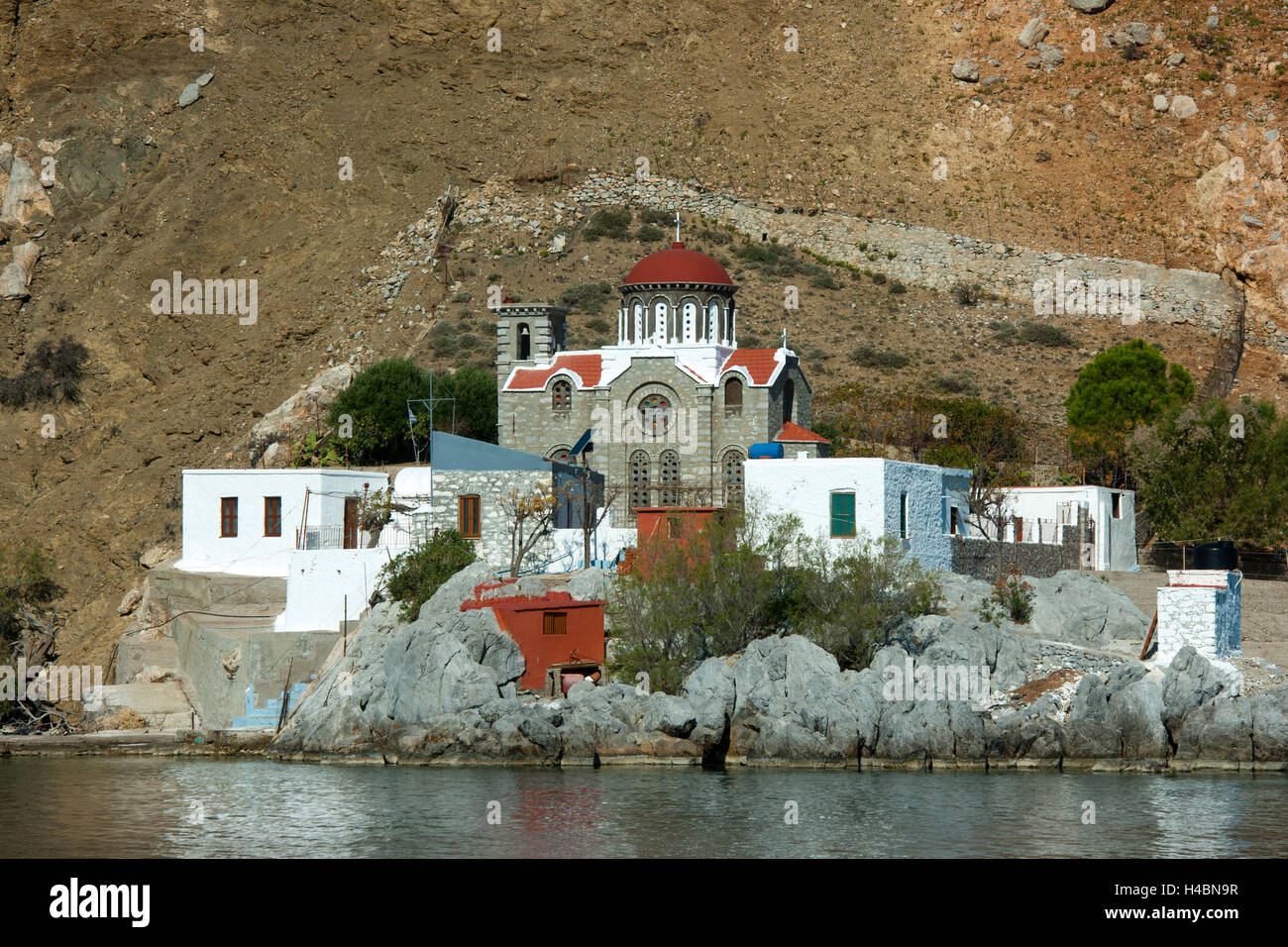 Greece, Symi, church Analipsi in the driveway to the harbour of Symi near the rock island Nimos