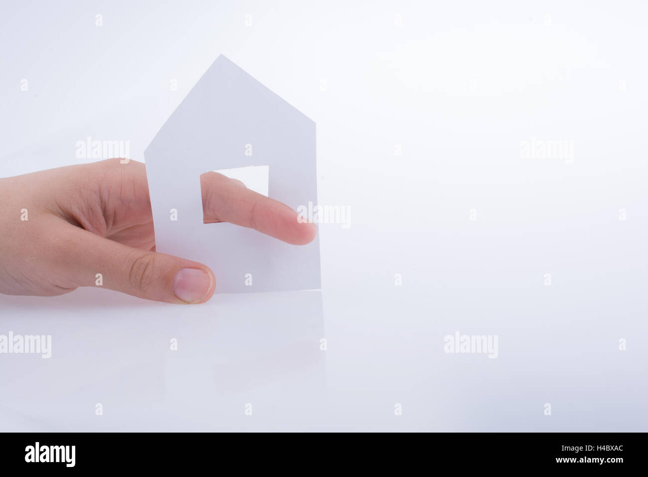 Hand holding a paper house on a white background Stock Photo - Alamy
