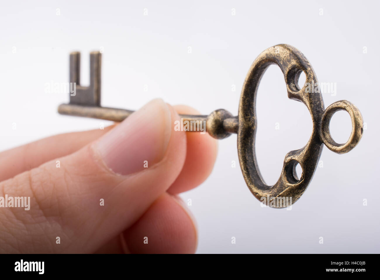 Hand holding a key on a white background Stock Photo - Alamy