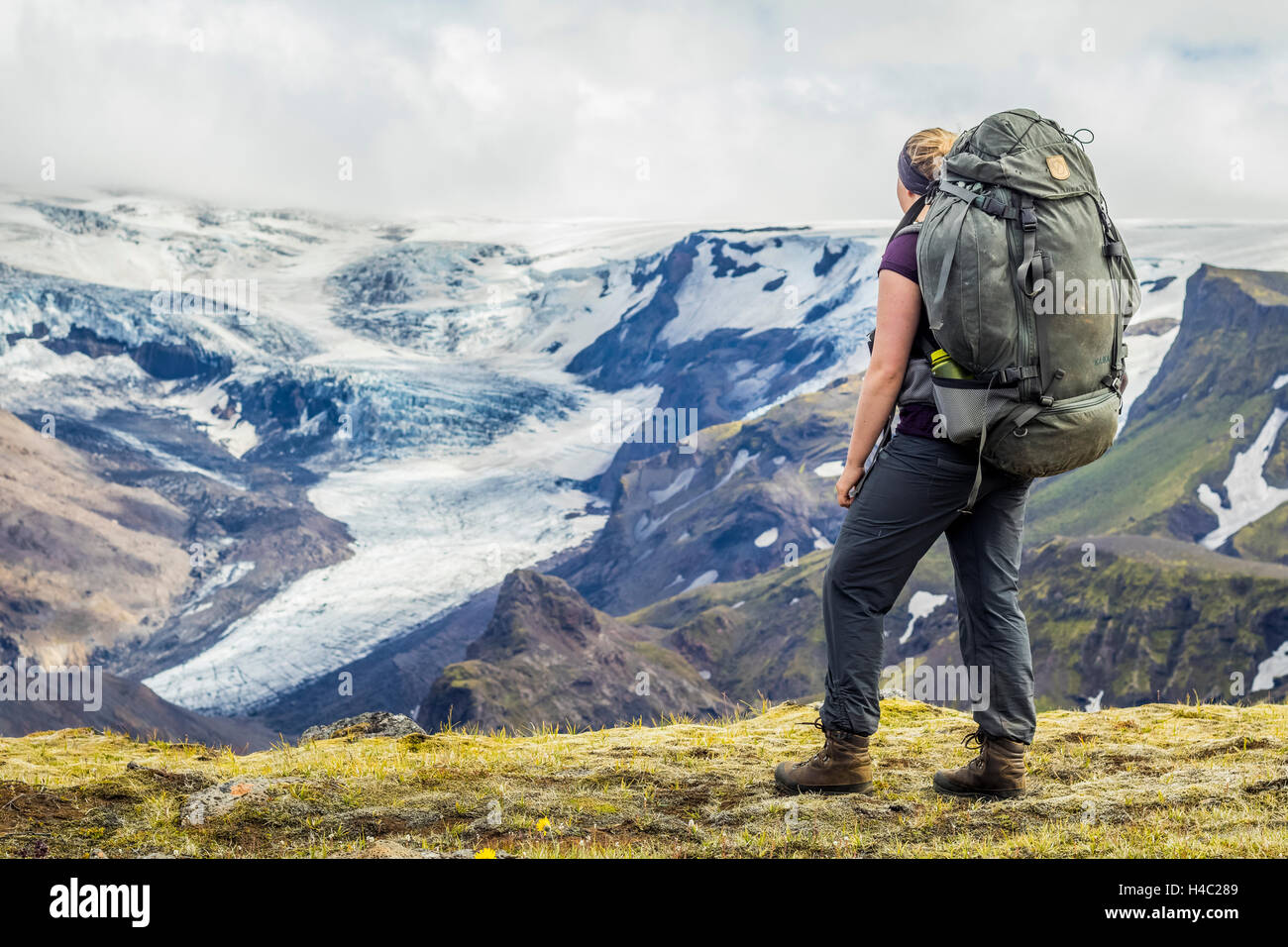A young hiker overlooking a glacier in Thorsmörk Stock Photo