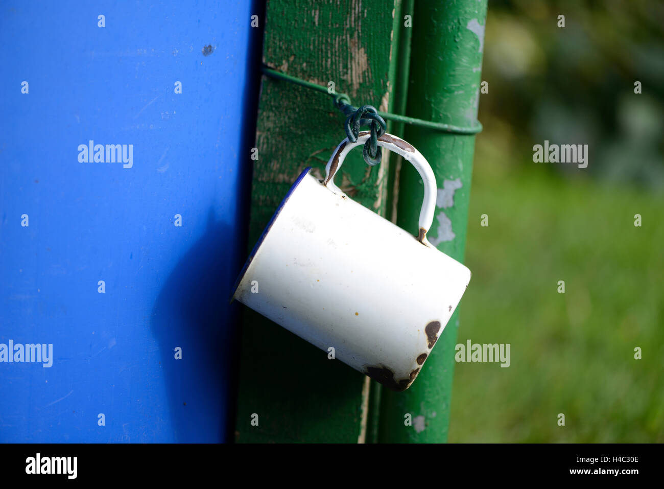 Cup, old, rusty, outdoors, hanging Stock Photo Alamy
