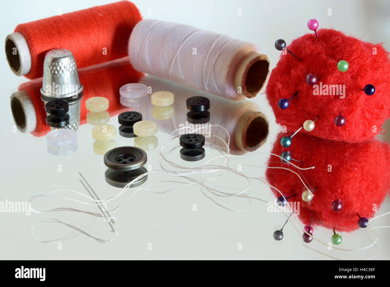 Sewing tools (and there reflection in the mirror Stock Photo Alamy