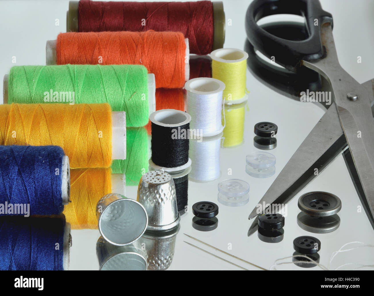 Sewing tools (and there reflection in the mirror Stock Photo Alamy