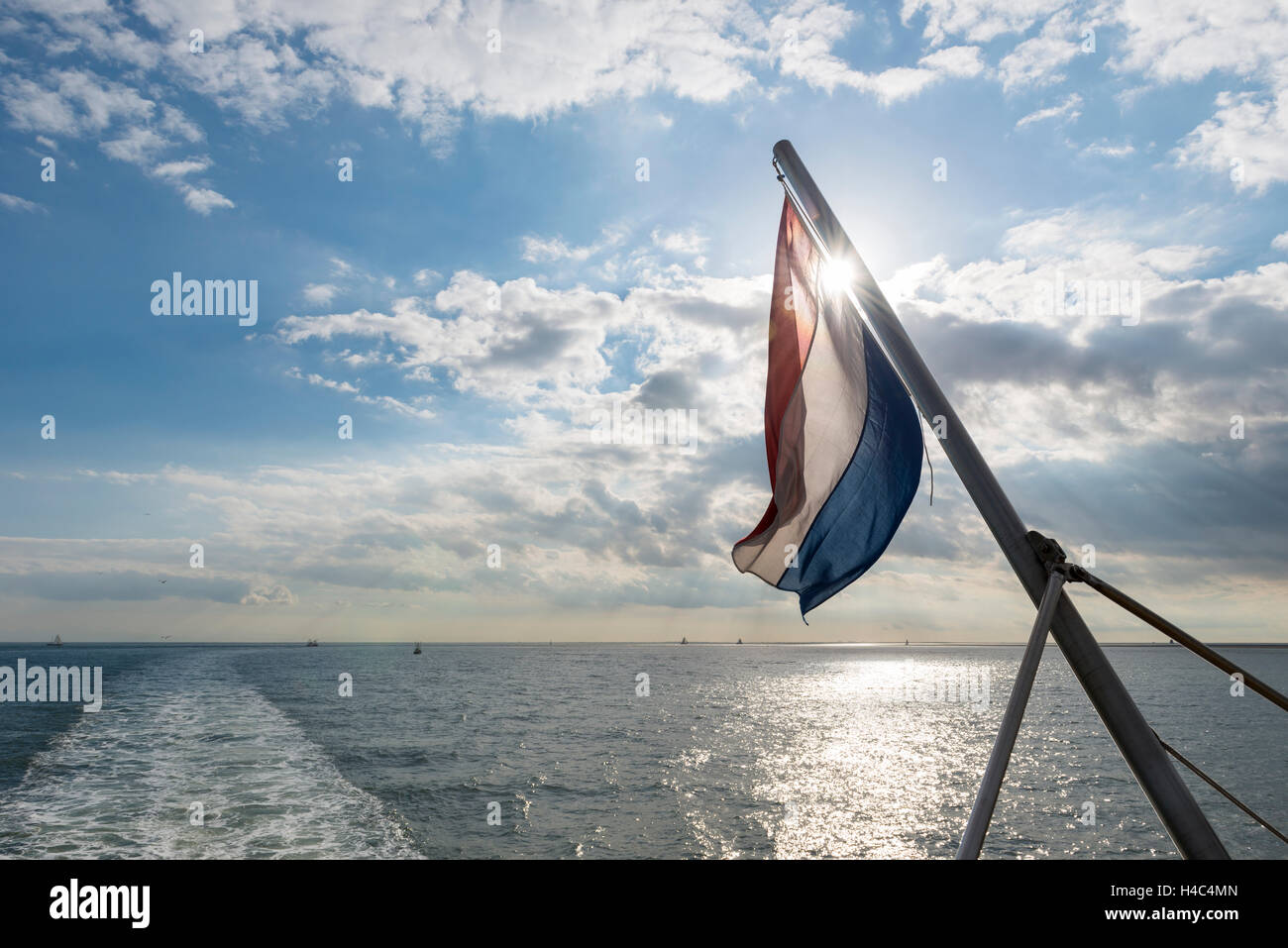 Wadden Sea with Dutch flag as seen from the ferry Stock Photo