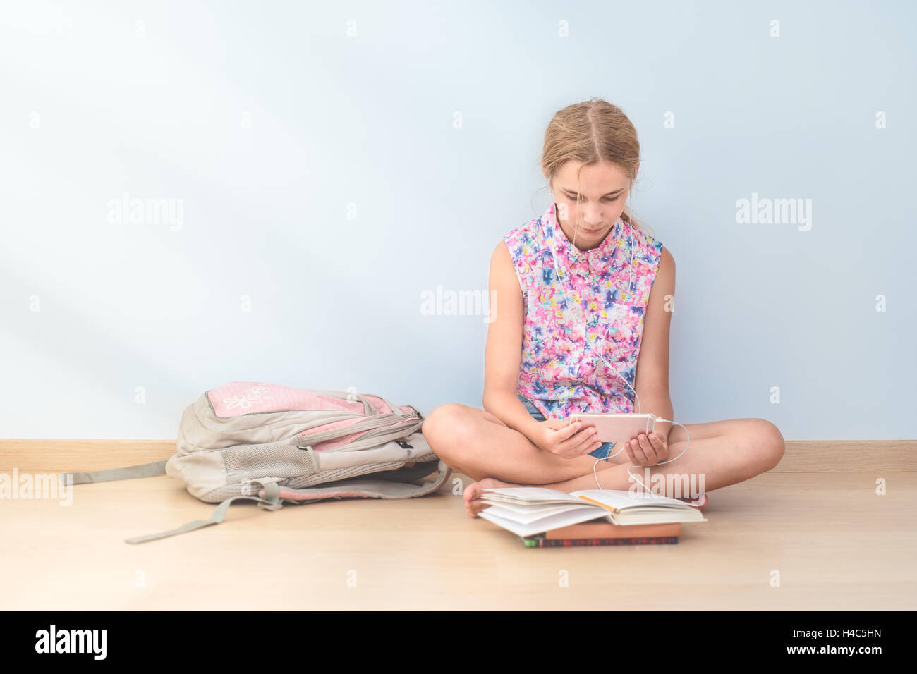 Schoolgirl reading a book in classroom Stock Photo