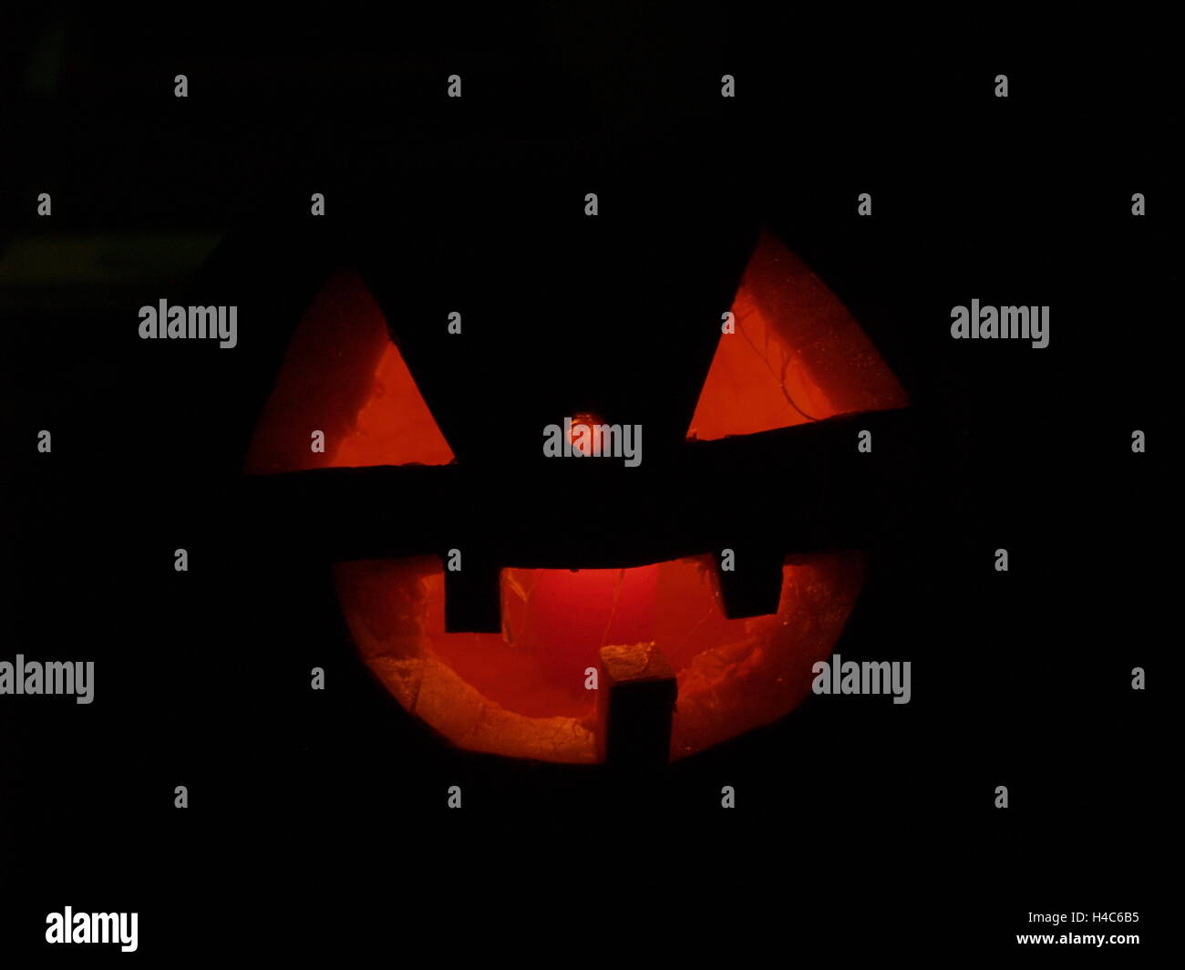 Scary Halloween pumpkins isolated on a black background. glowing faces ...