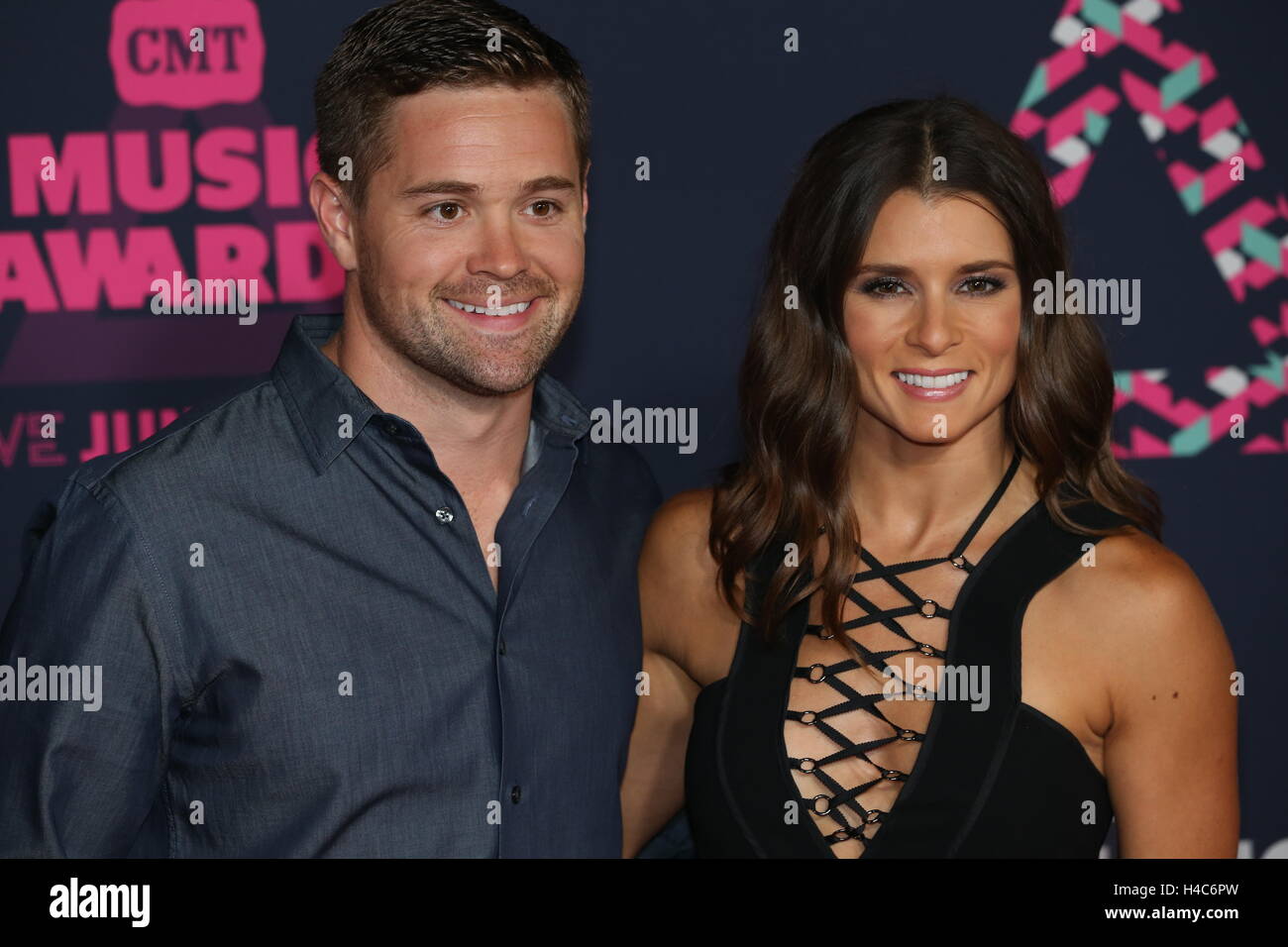 Ricky Stenhouse Jr. walks wife Danica Patrick down the red carpet at the CMT Music Awards at Bridgestone Arena on June 8th, 2016 in Nashville, TN. Stock Photo