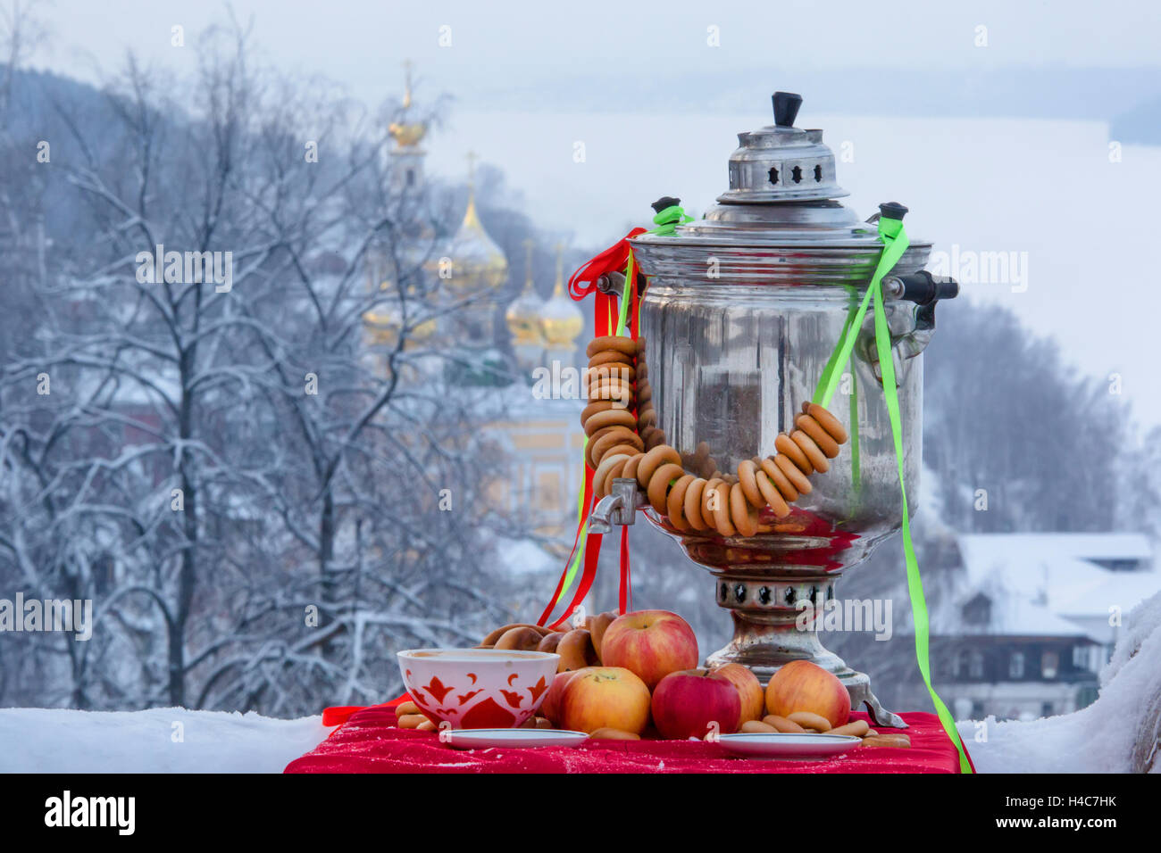 Traditional Russian tea with samovar on the background of old Russian city as part of the Goden Ring touristic route Stock Photo