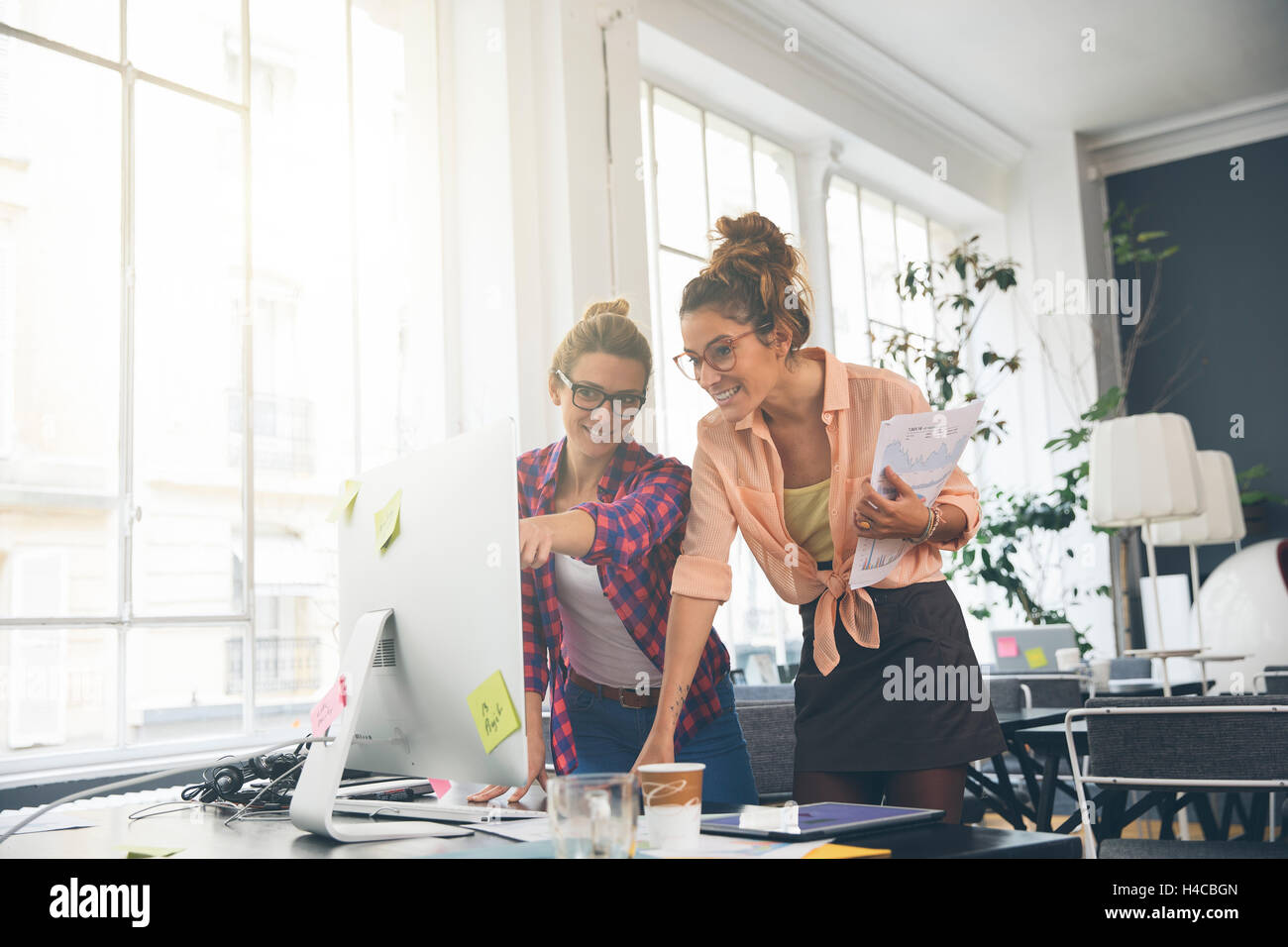 Two women working together in office Stock Photo